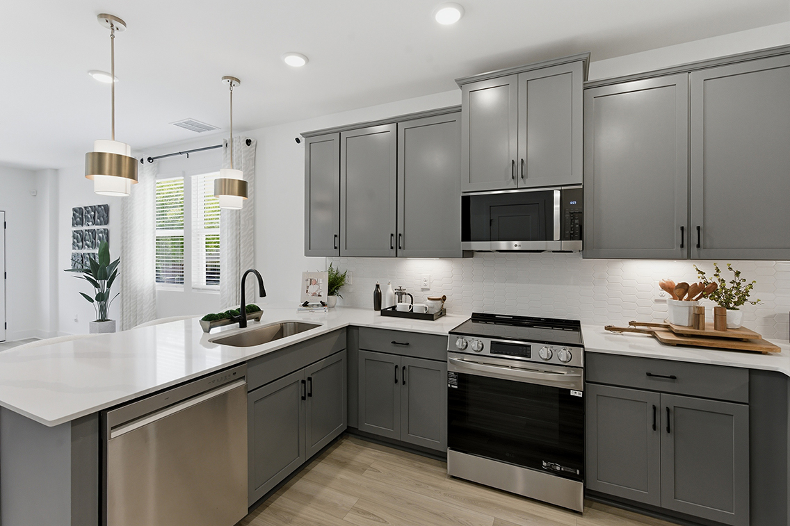 A kitchen with white cabinets.