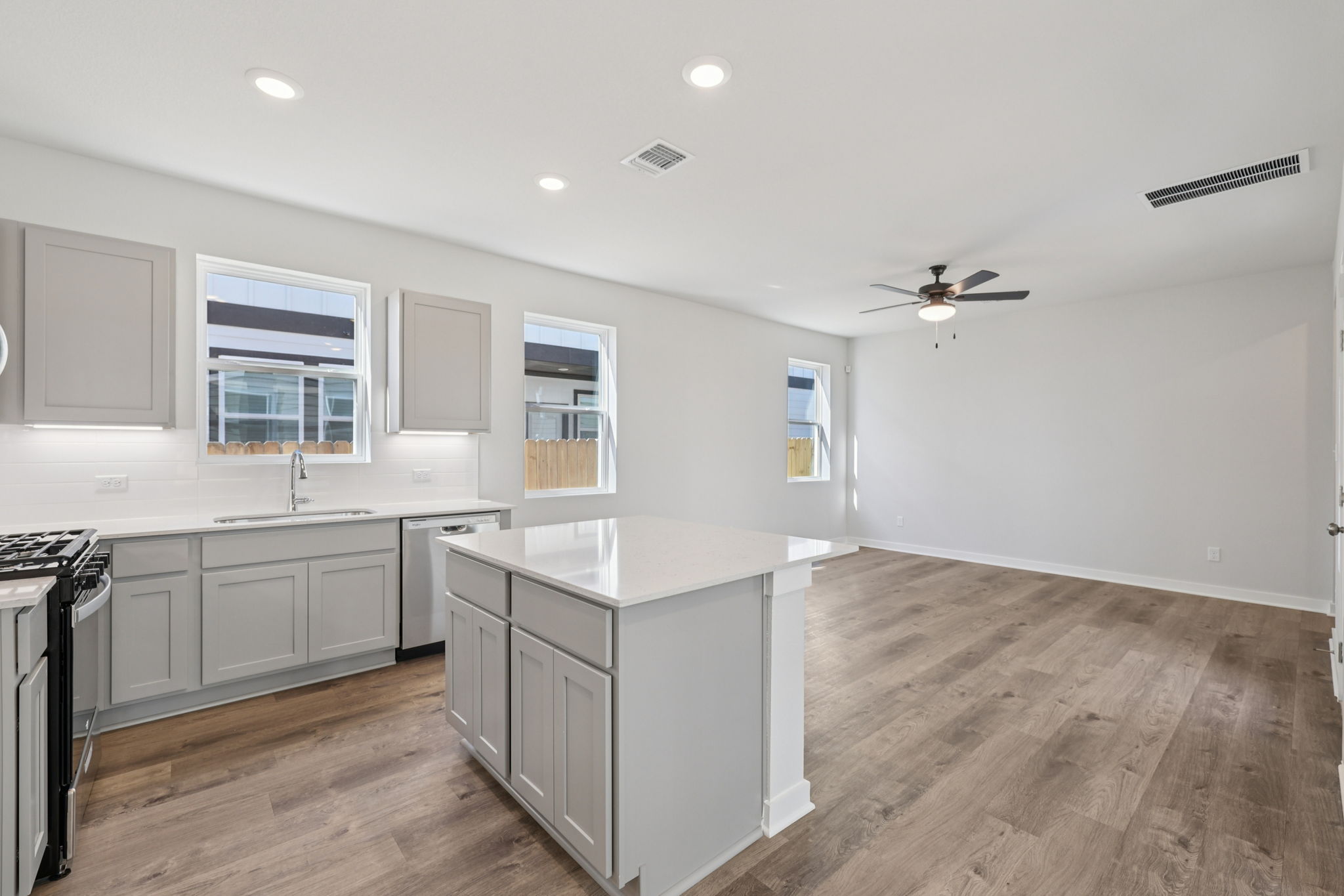 A kitchen with white cabinets.