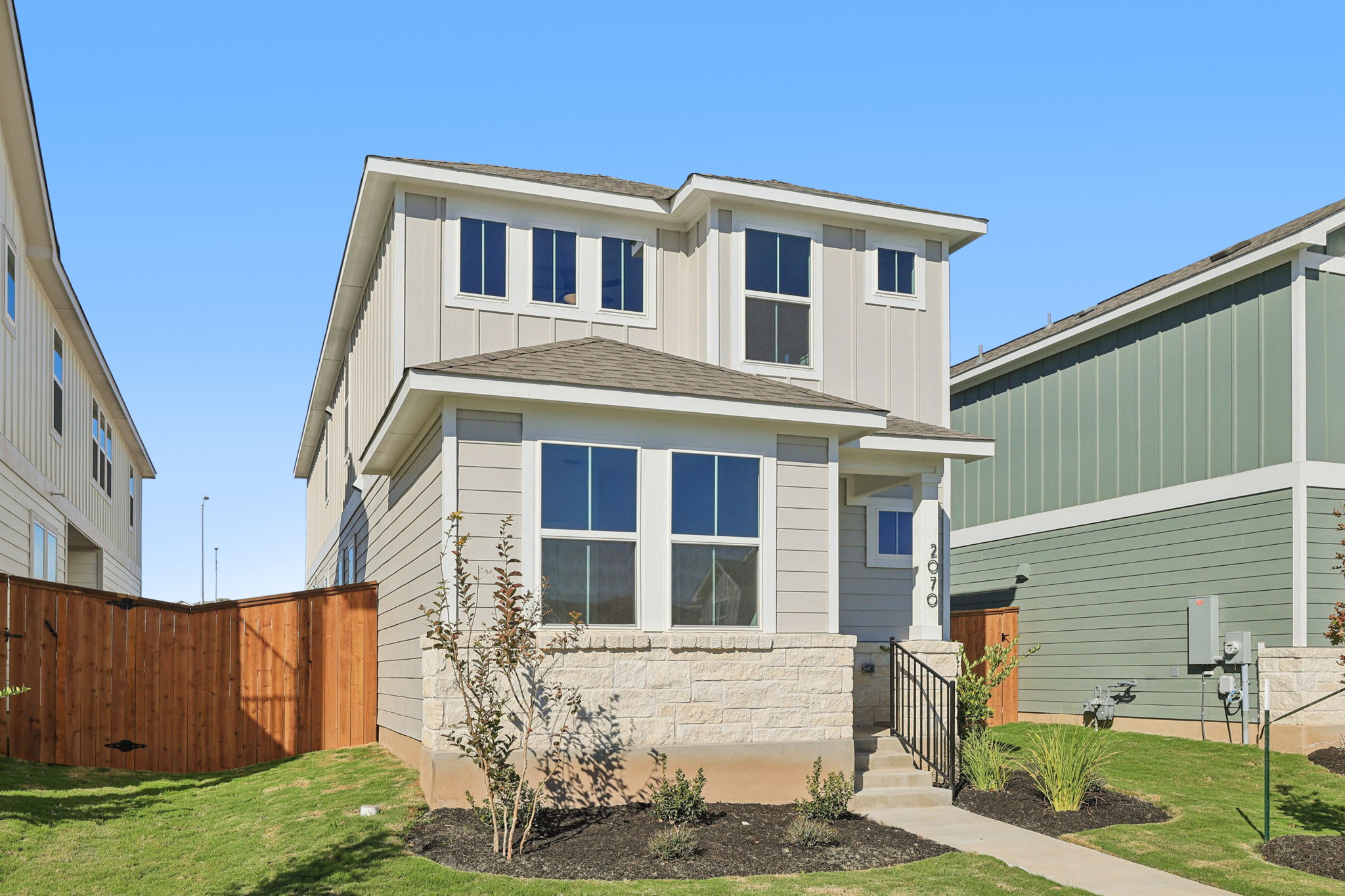 A white house with a fence.