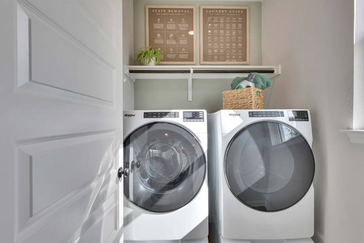A white washing machine and a white door.