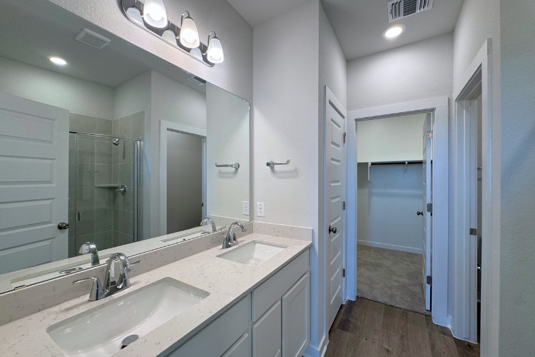 A bathroom with a large mirror.