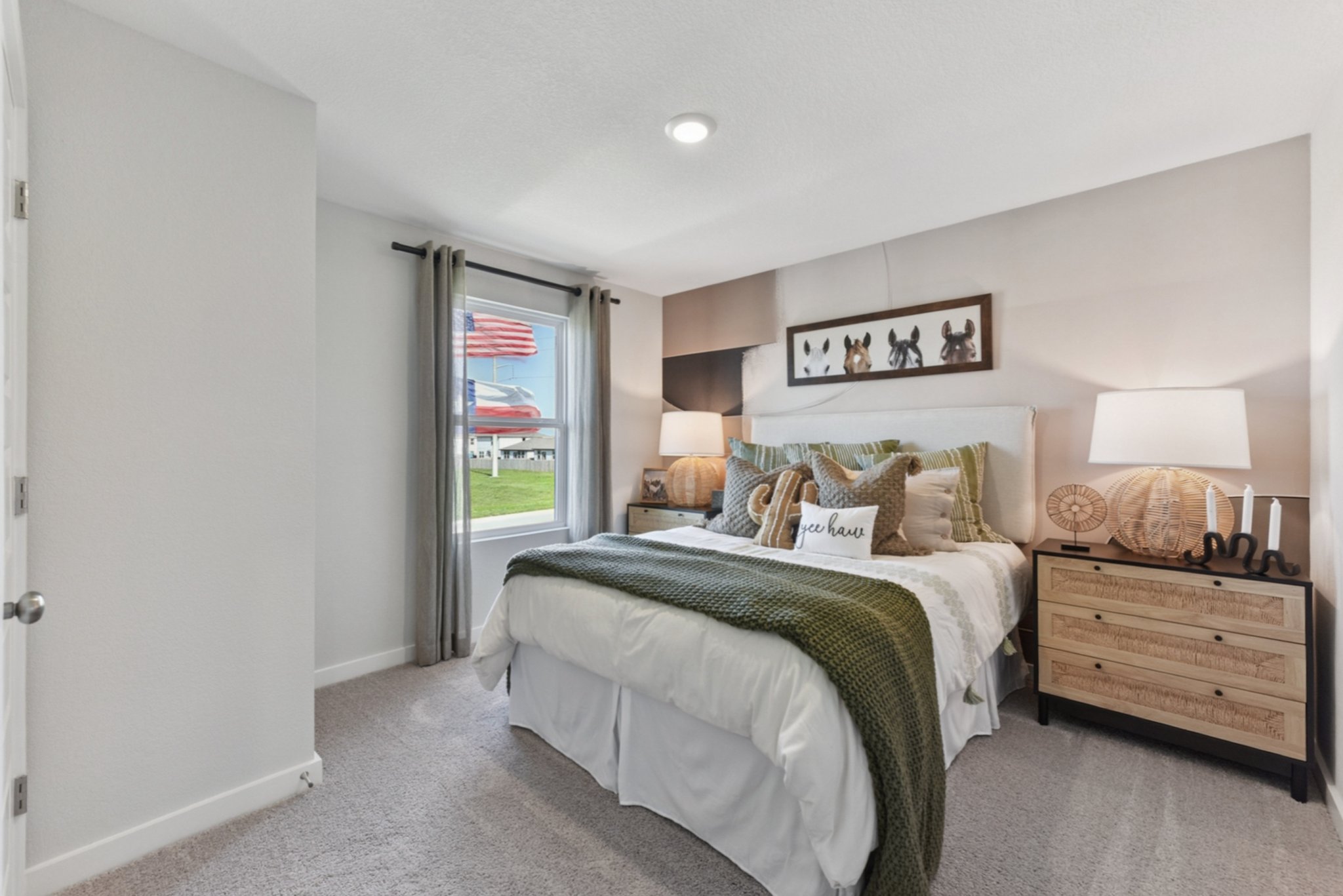 A bedroom with a bed and a dresser.
