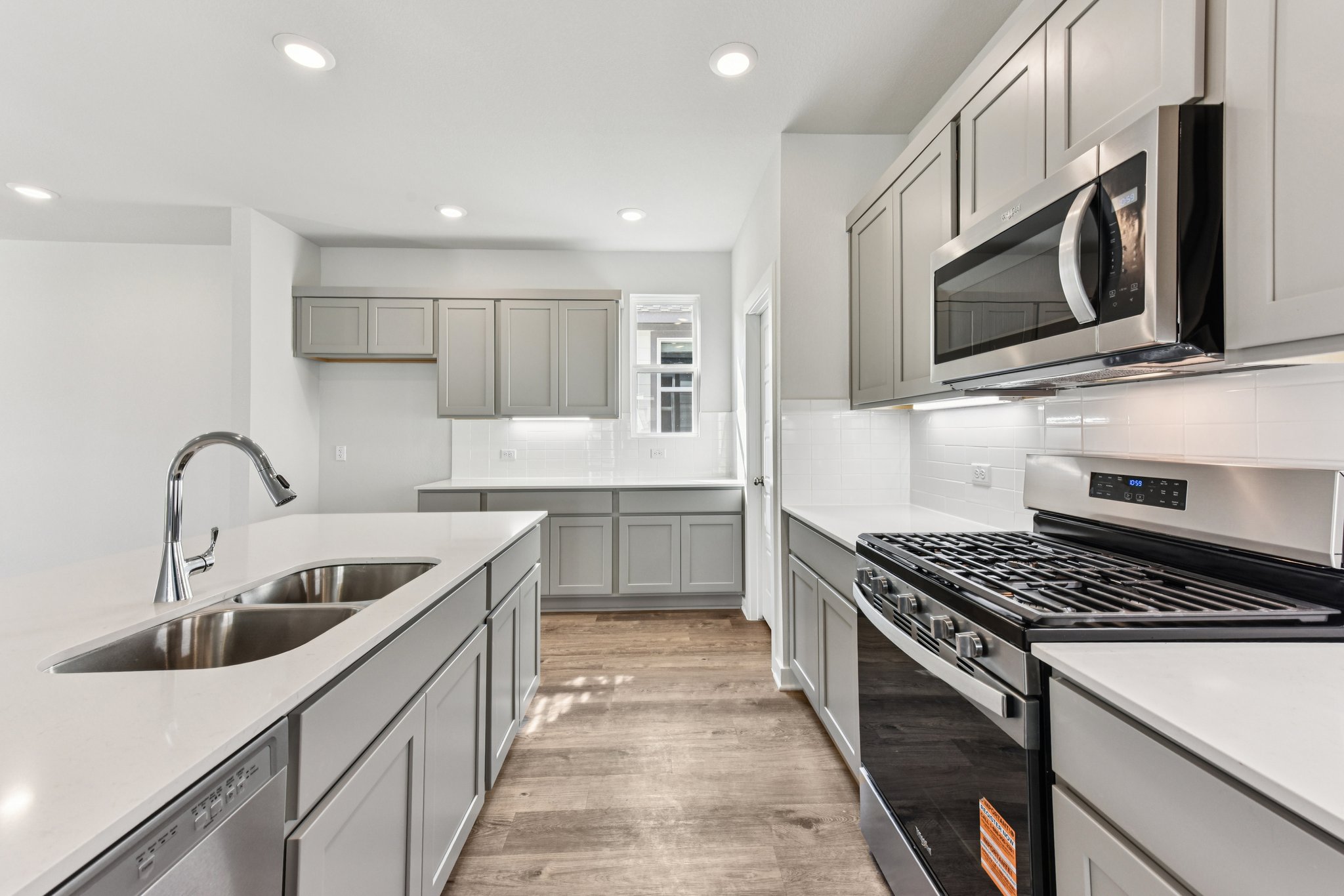 A kitchen with white cabinets.