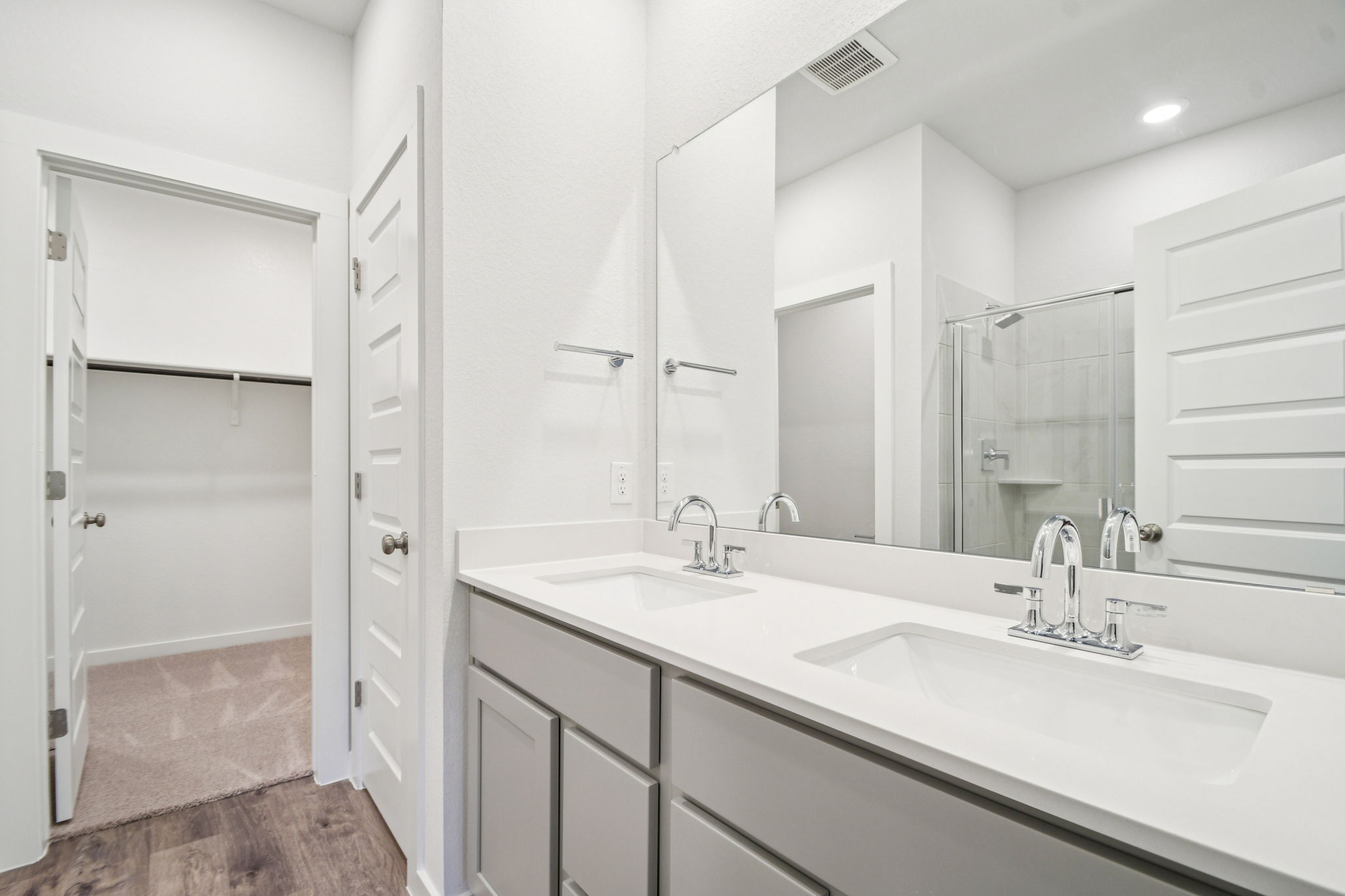 A bathroom with a large mirror.