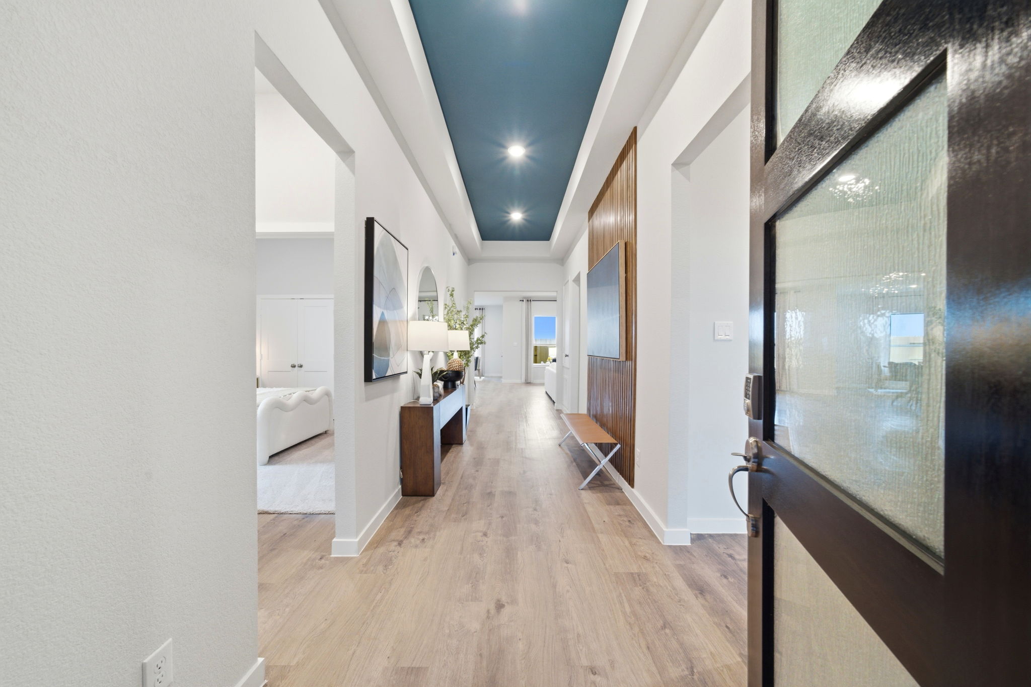 A room with a bed and a mirror.