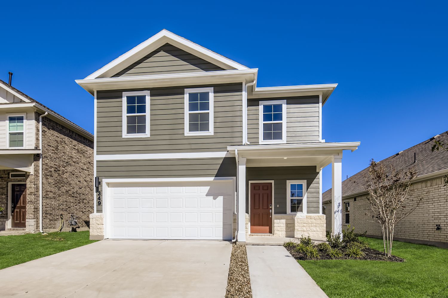 A white house with a garage.