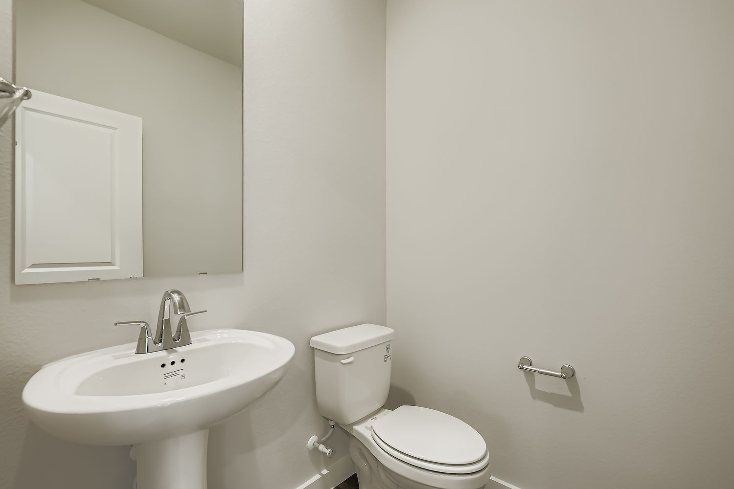 A bathroom with a toilet and sink.