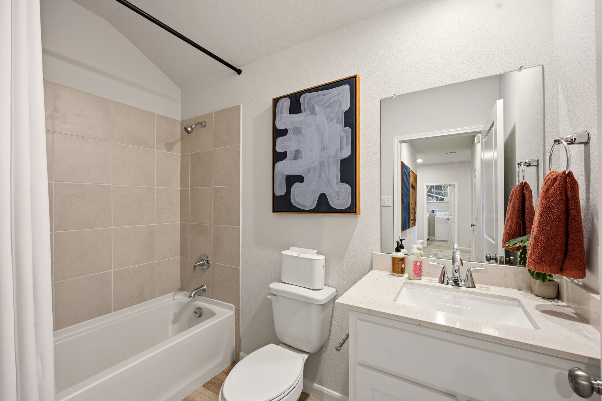 A bathroom with a sink toilet and a bathtub.