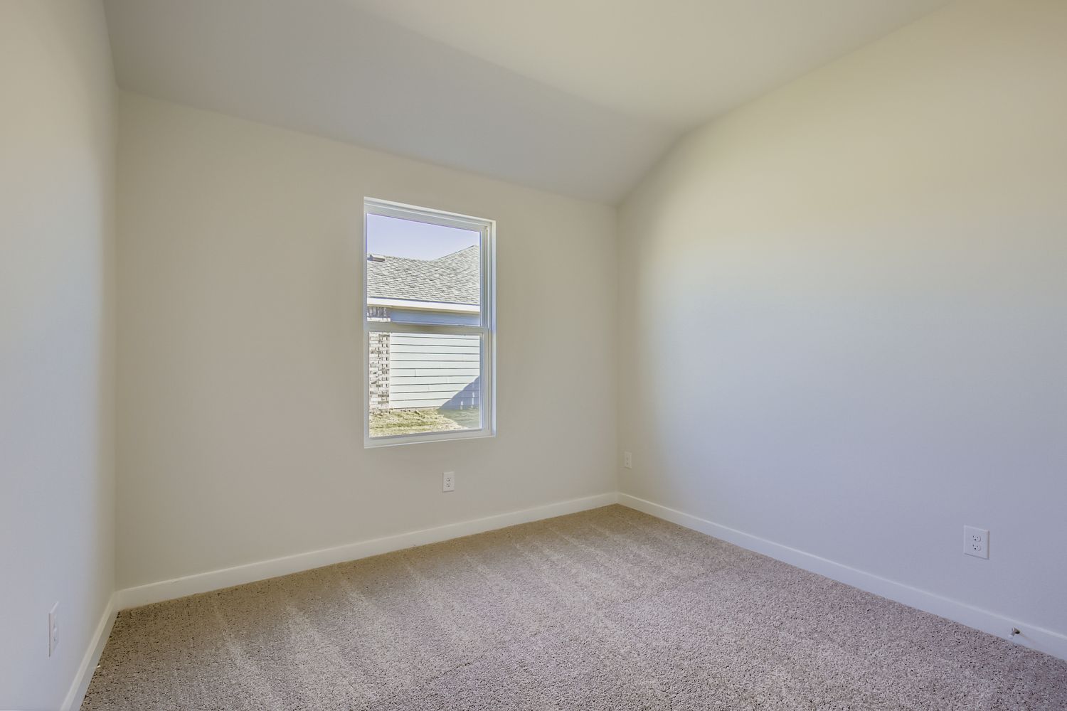 A room with a window and carpet.
