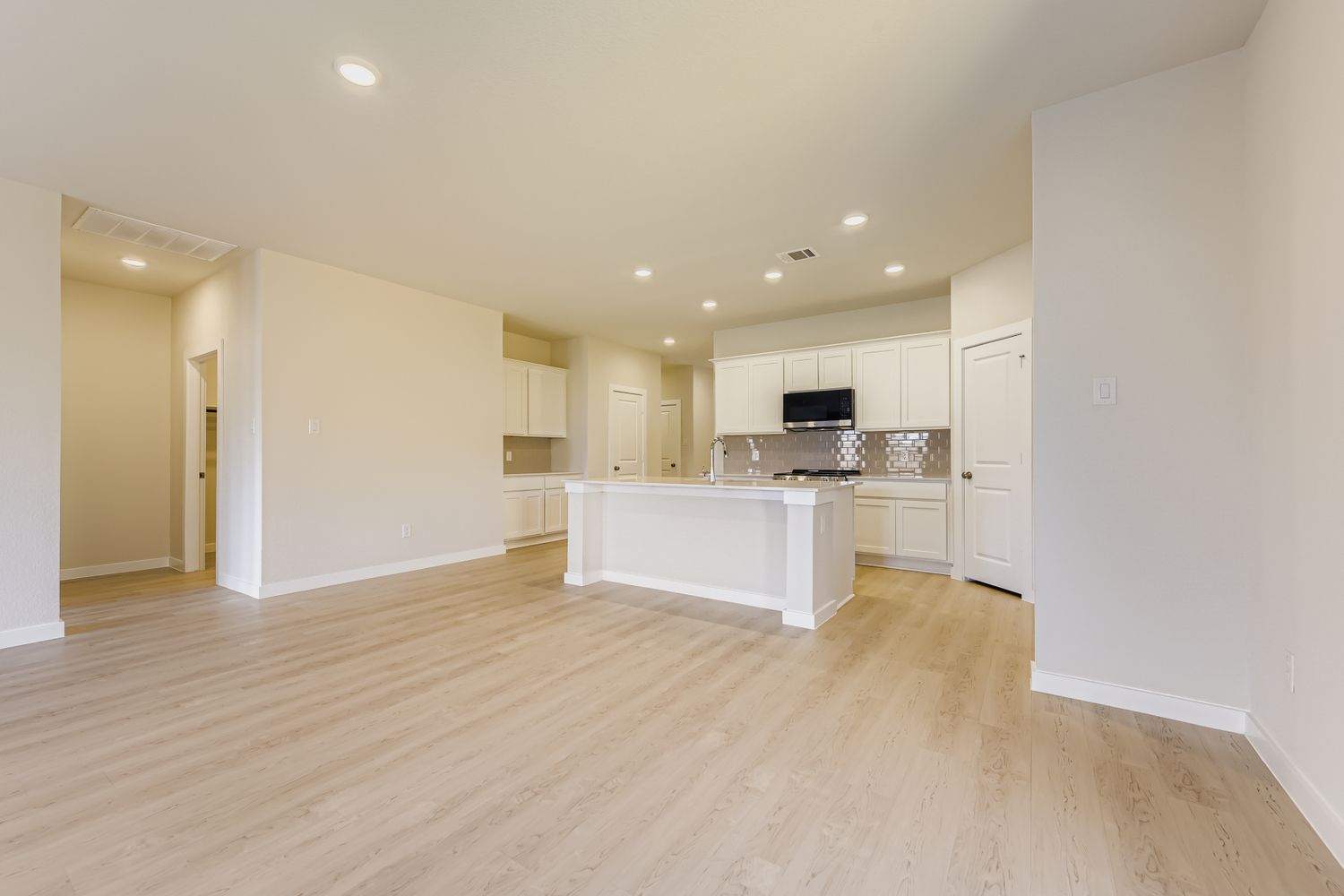 A large kitchen with white cabinets.