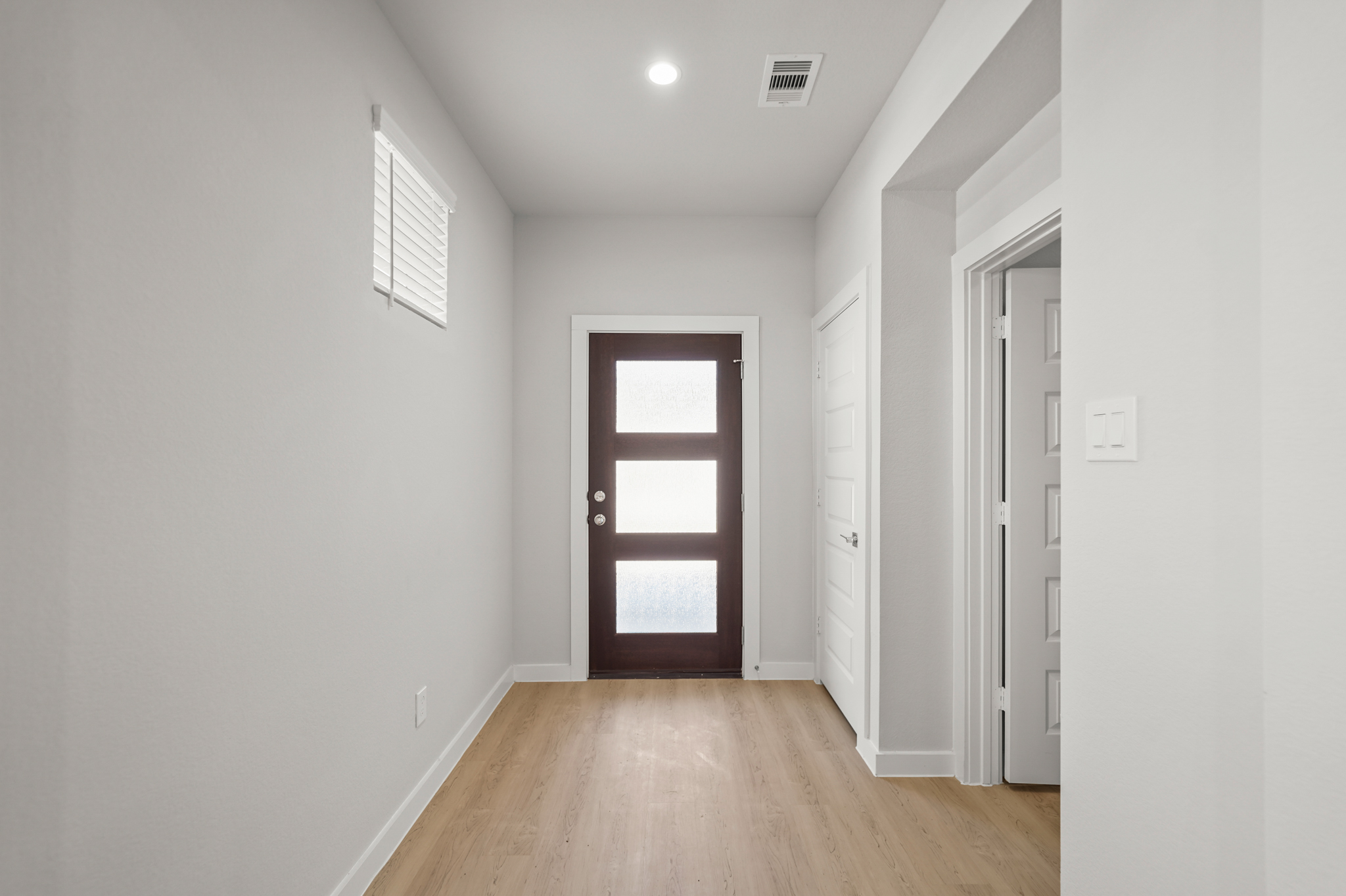A hallway with white walls.