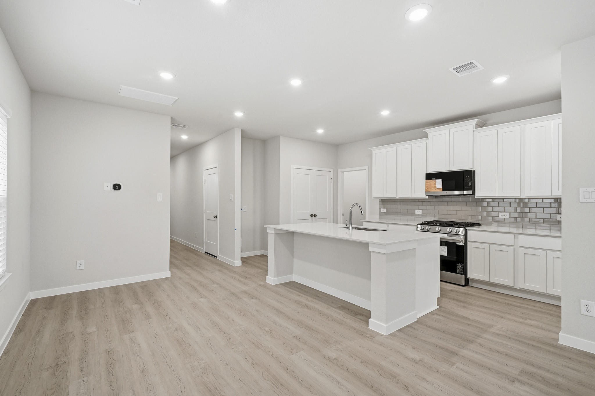 A kitchen with white cabinets.