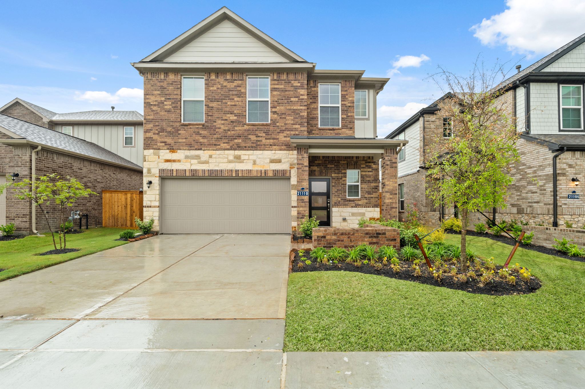 A brick house with a driveway.