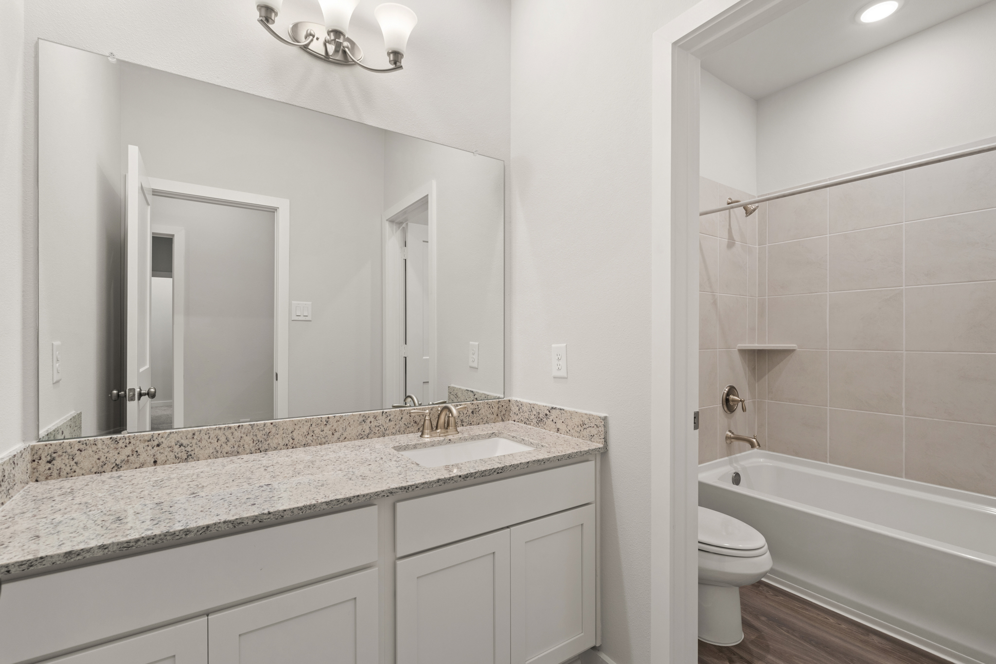 A bathroom with a marble countertop.