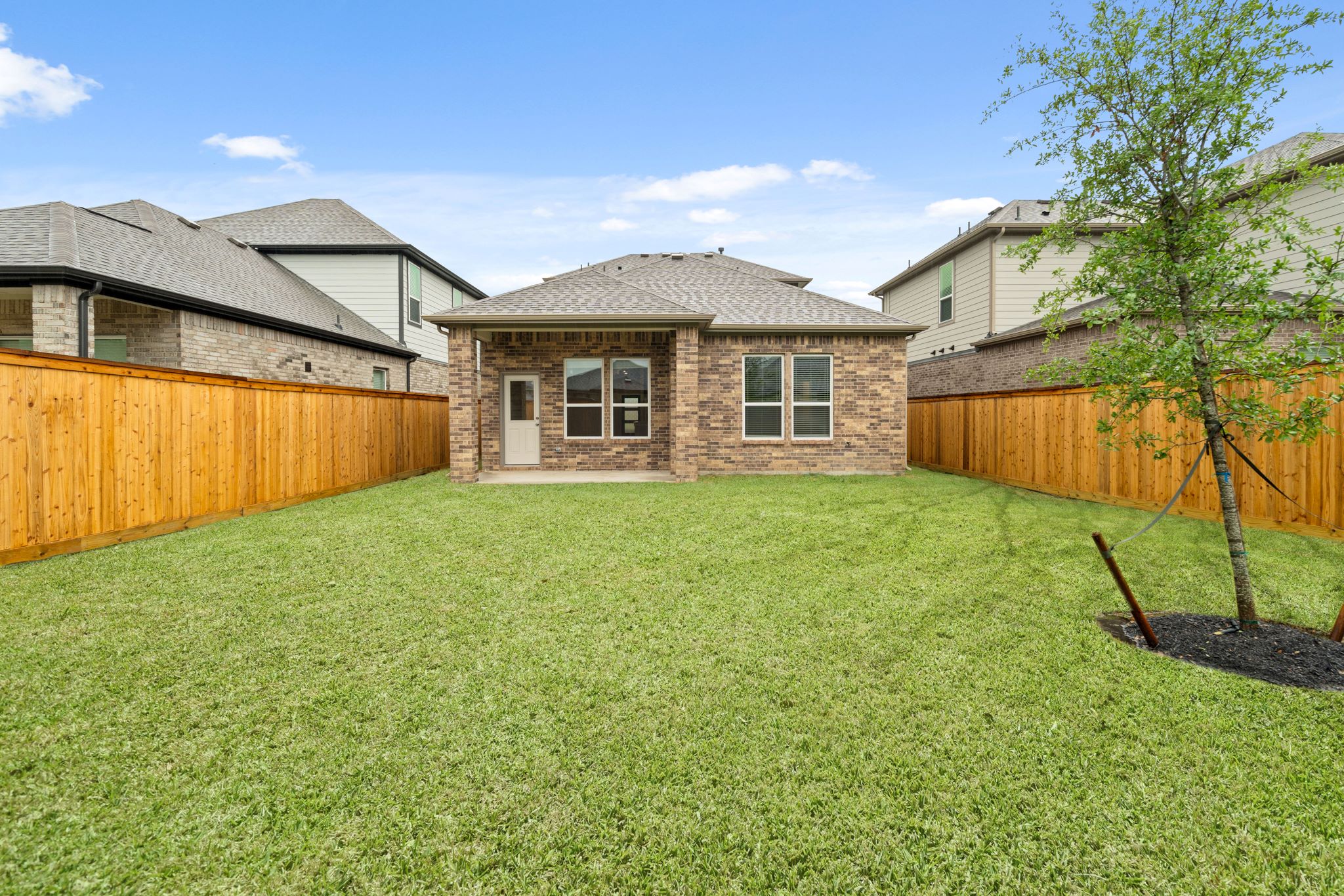 A house with a fence and trees.