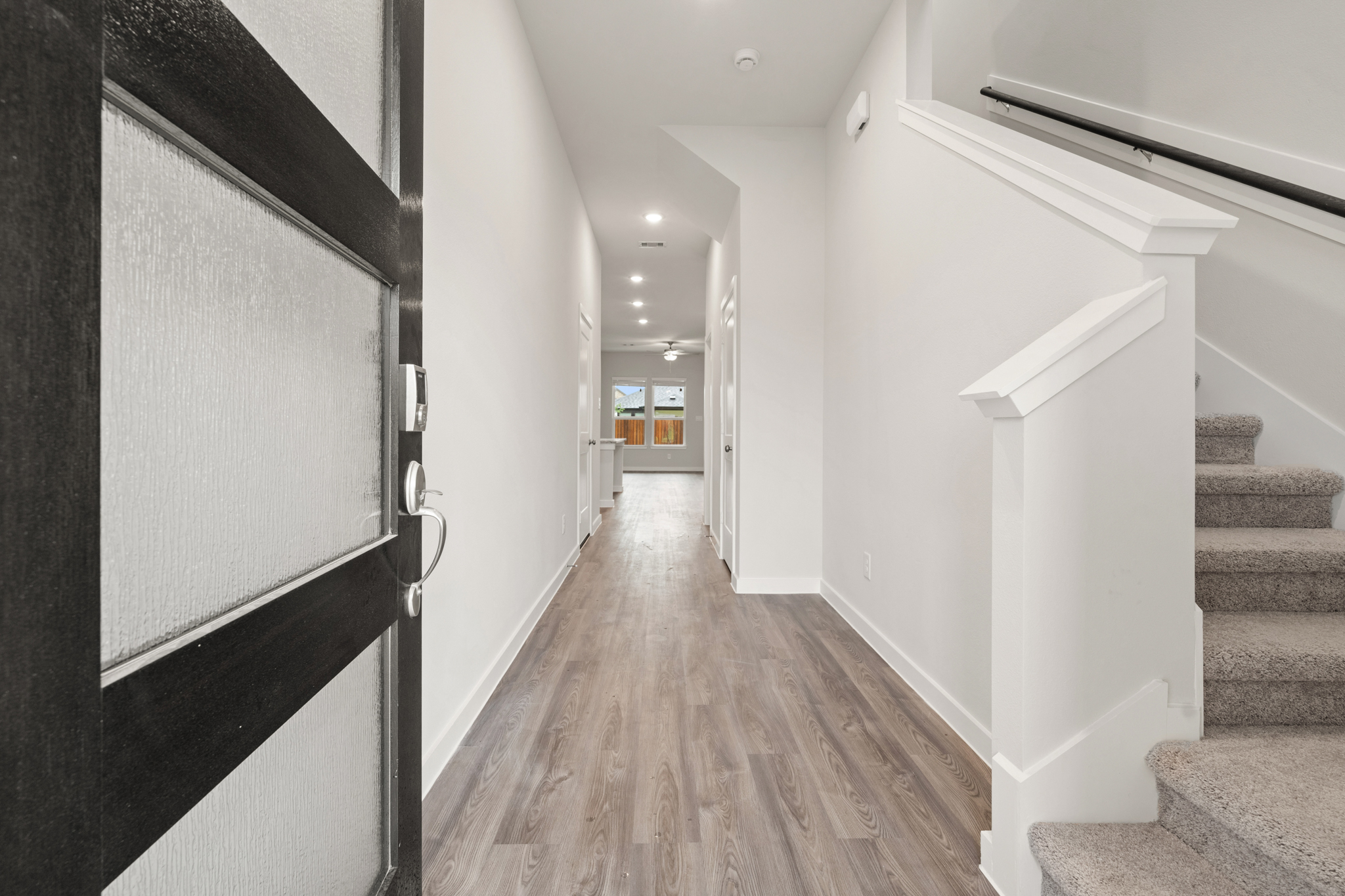 A hallway with white walls.