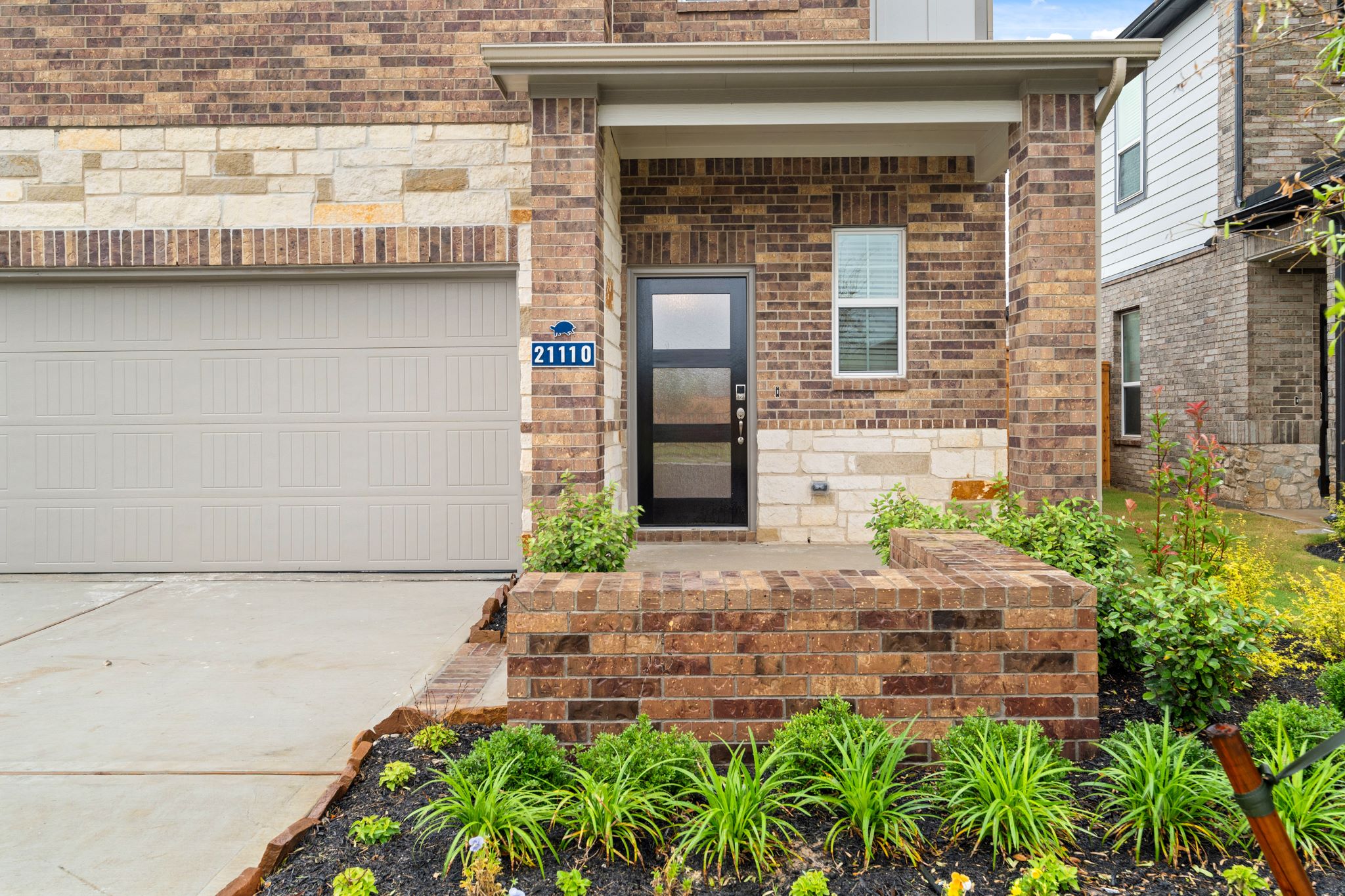 A brick building with a black door.