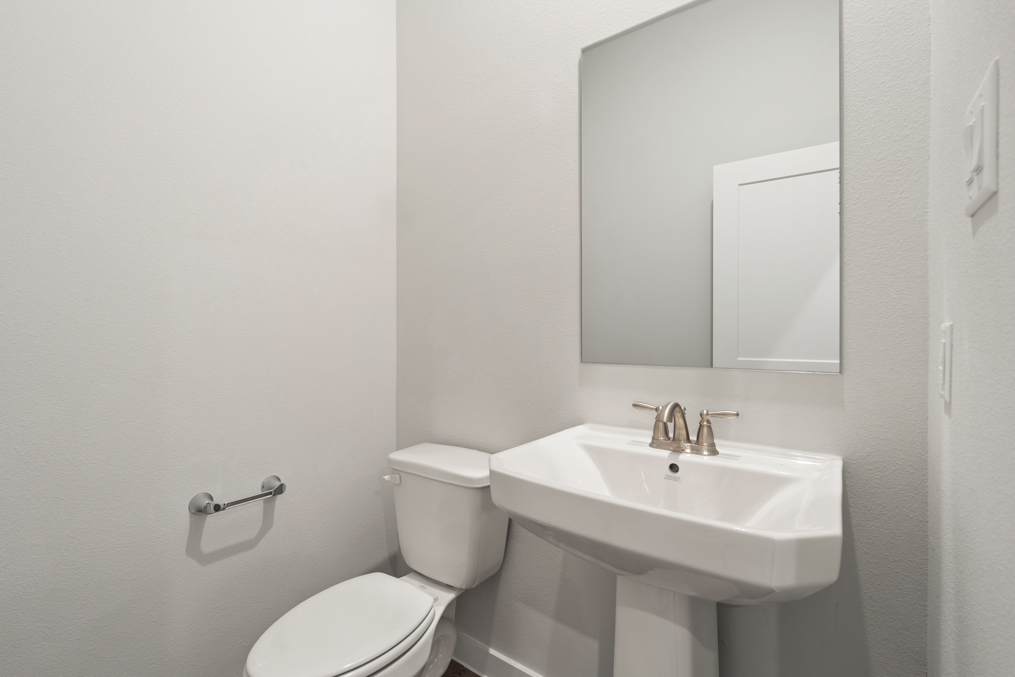 A bathroom with a toilet and sink.