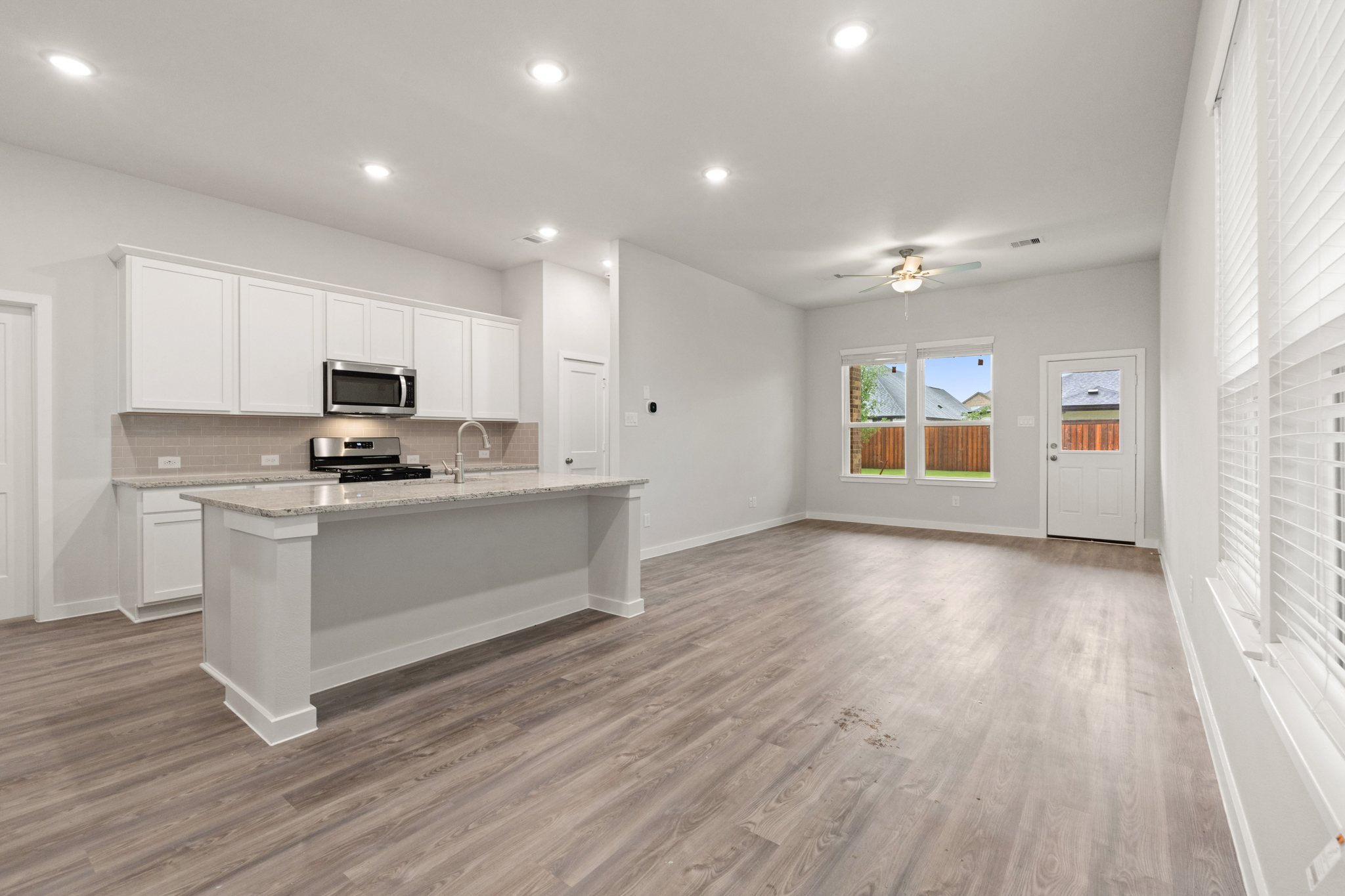 A kitchen with white cabinets.