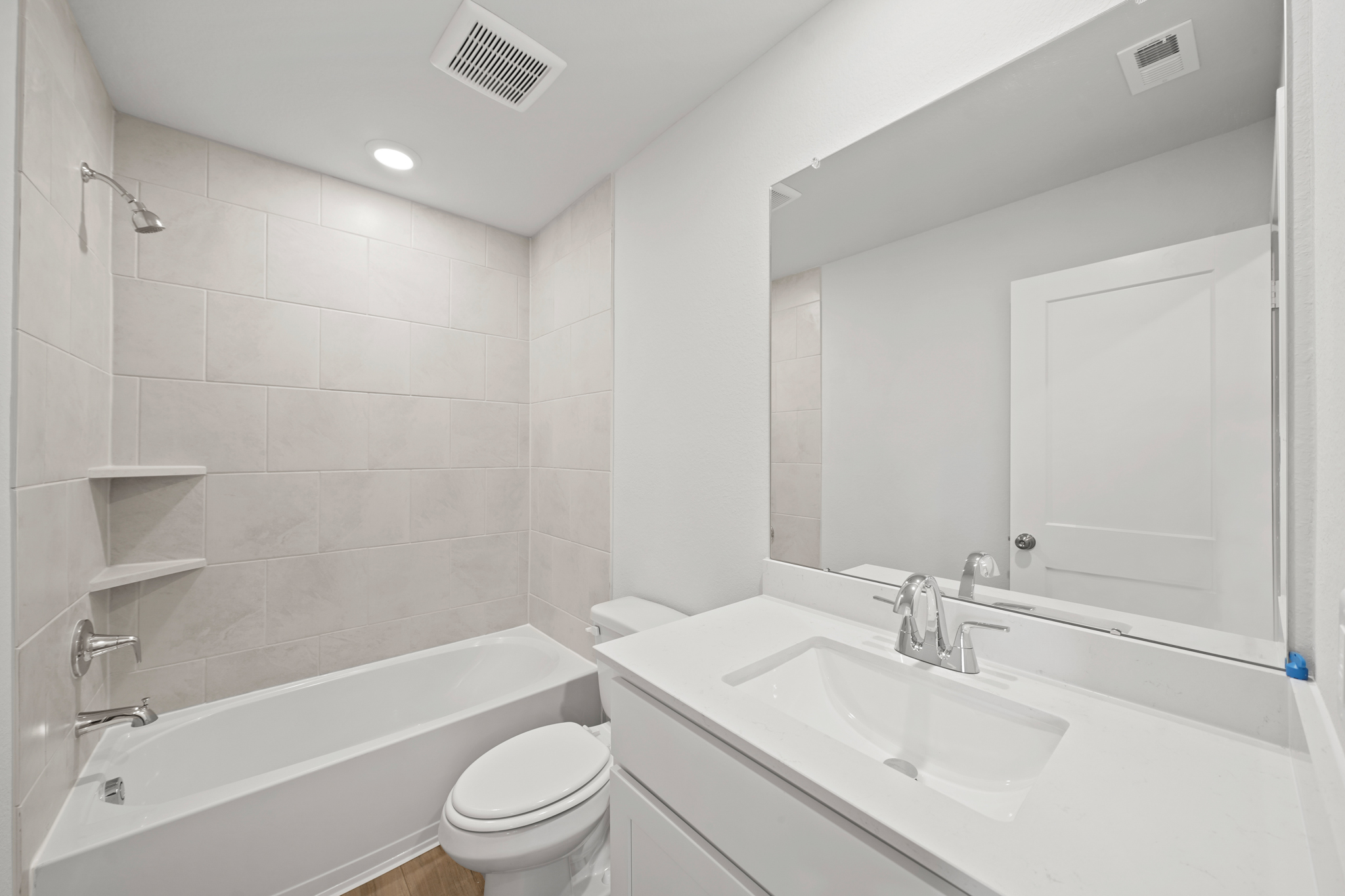 A bathroom with a tub sink and toilet.