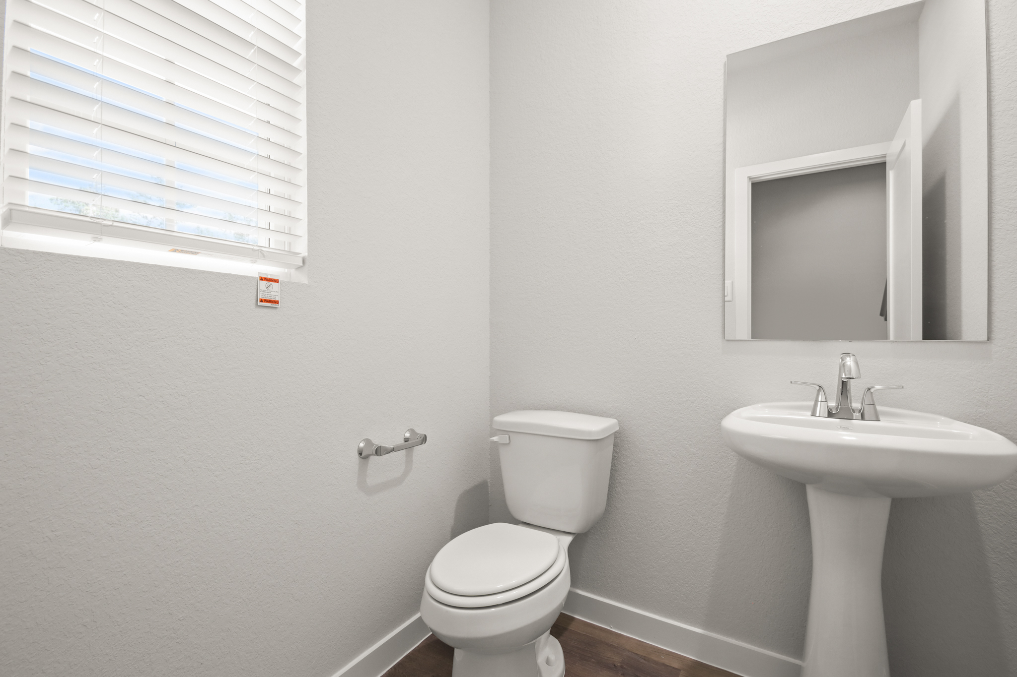 A bathroom with a toilet and sink.