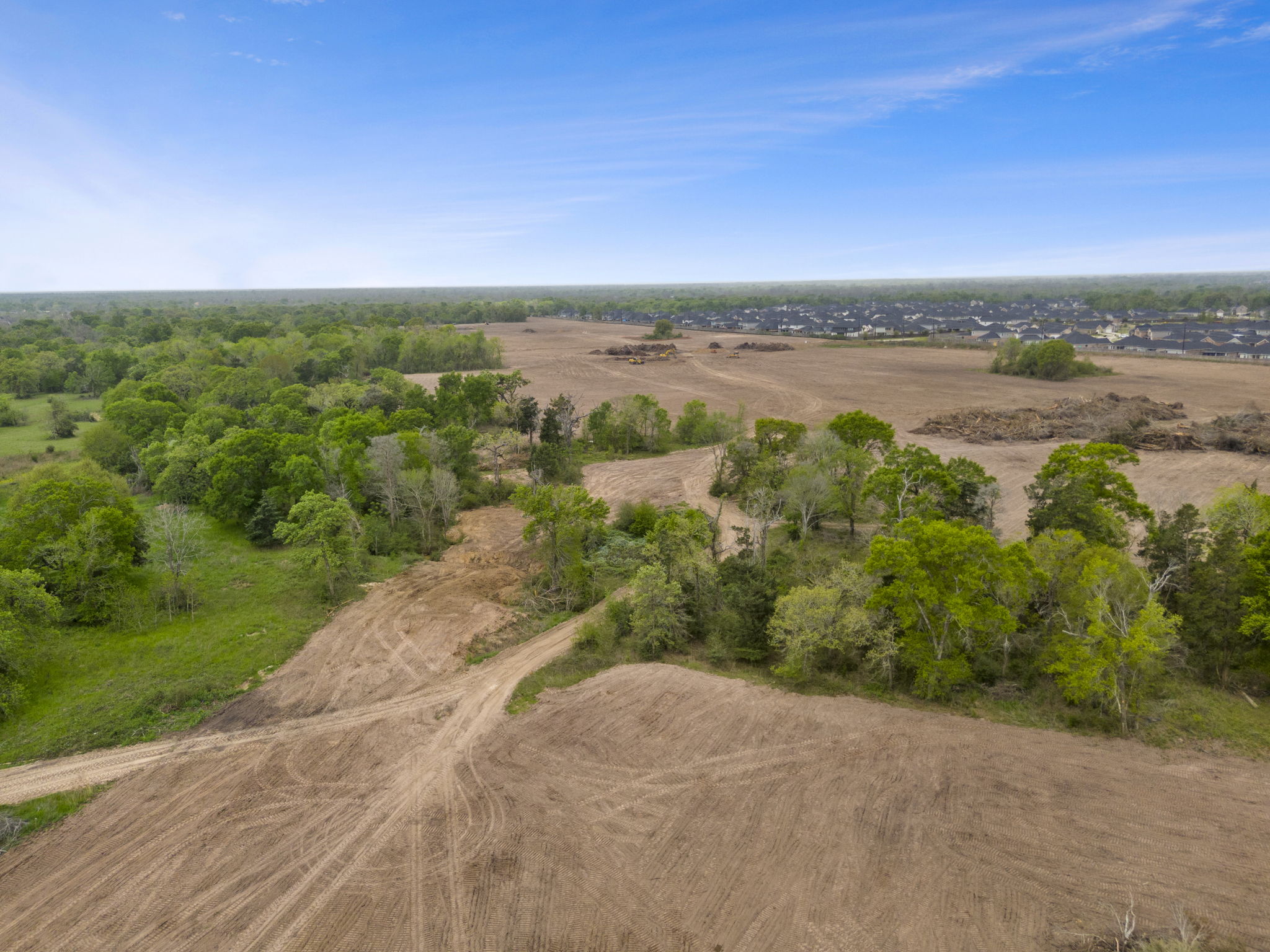 A dirt road with trees on the side.
