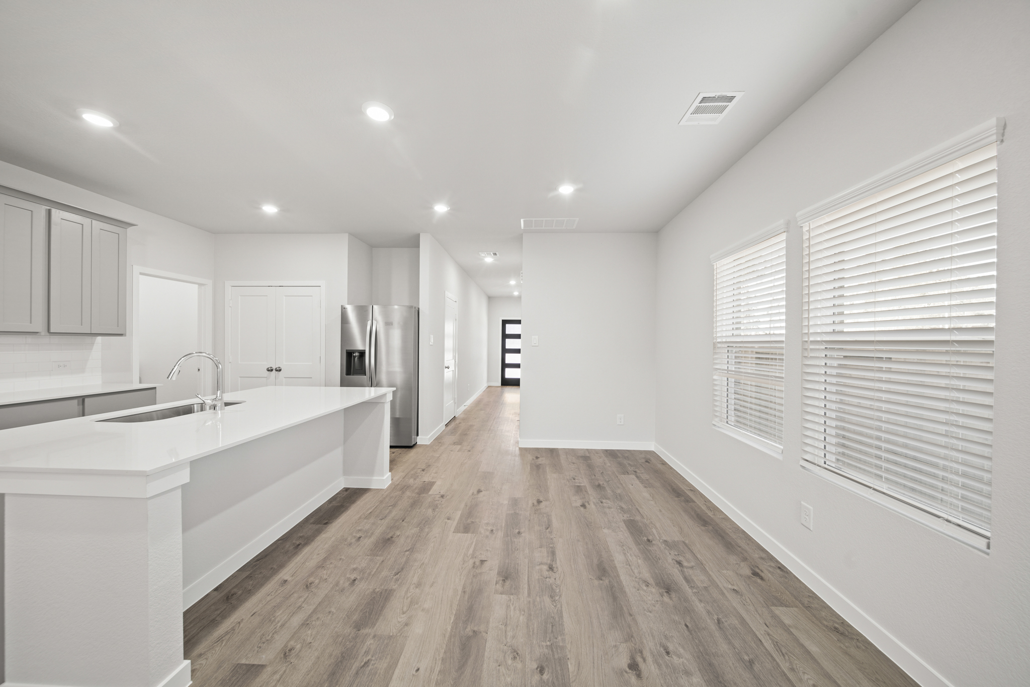 A kitchen with white cabinets.