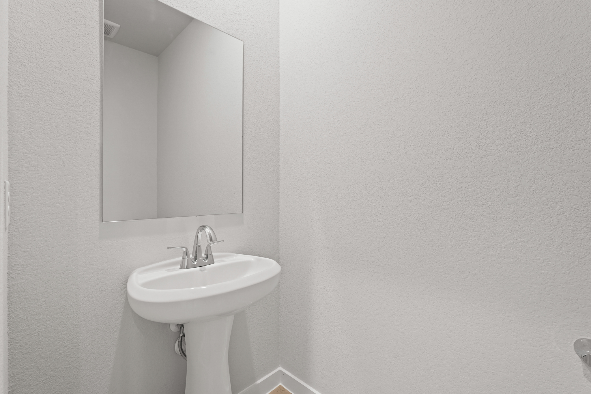 A bathroom with a mirror and sink.