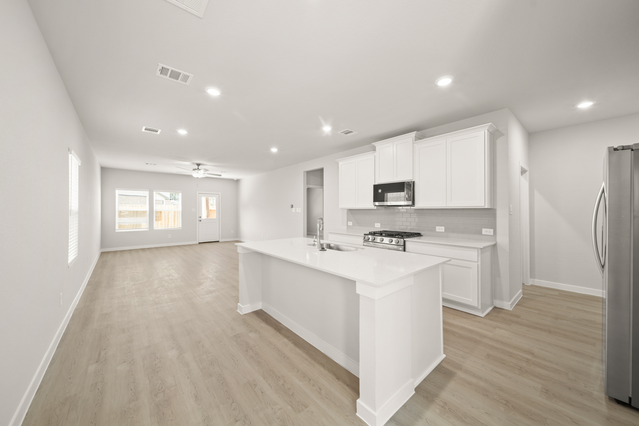 A kitchen with white cabinets.
