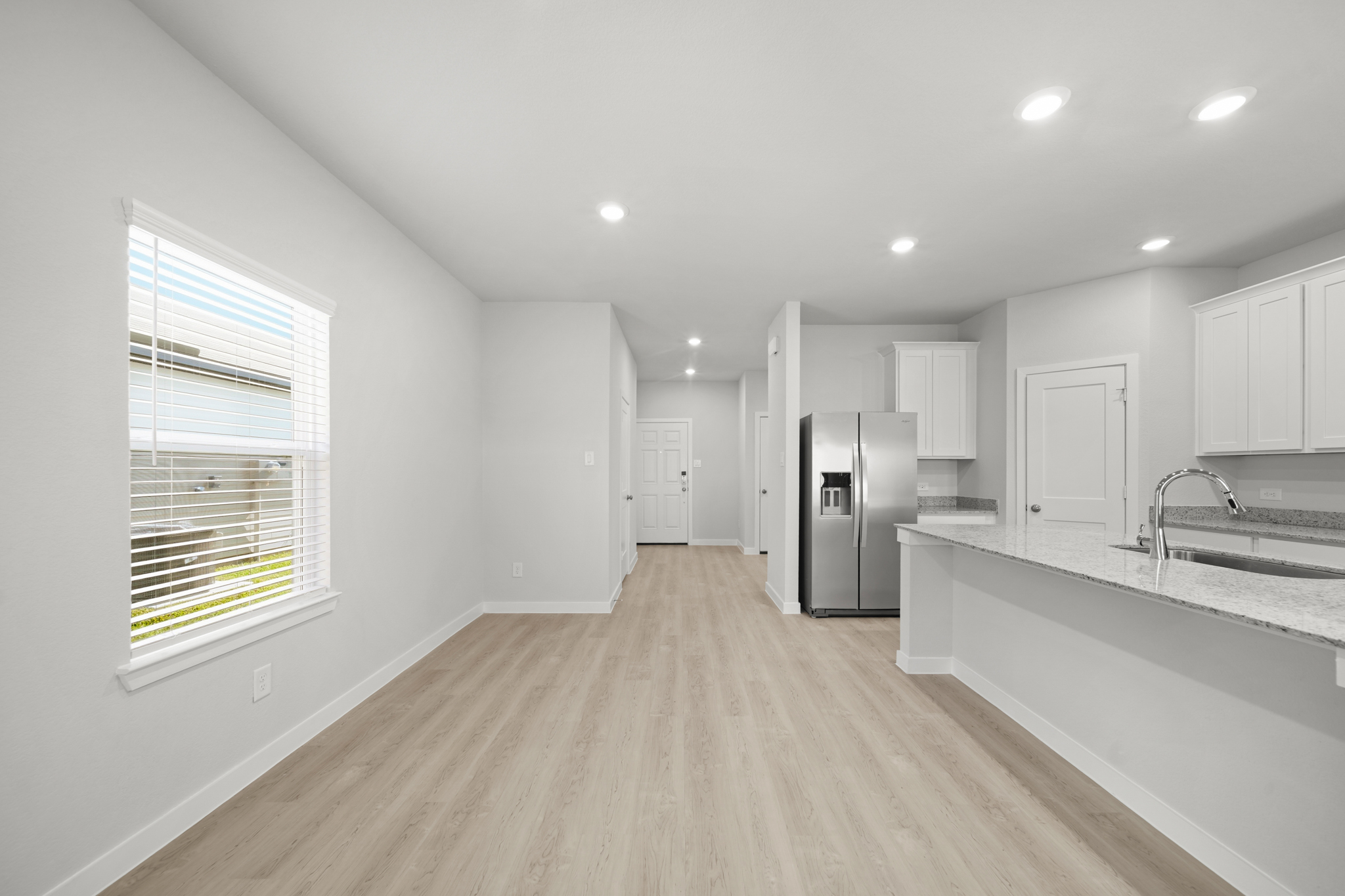 A kitchen with white cabinets.