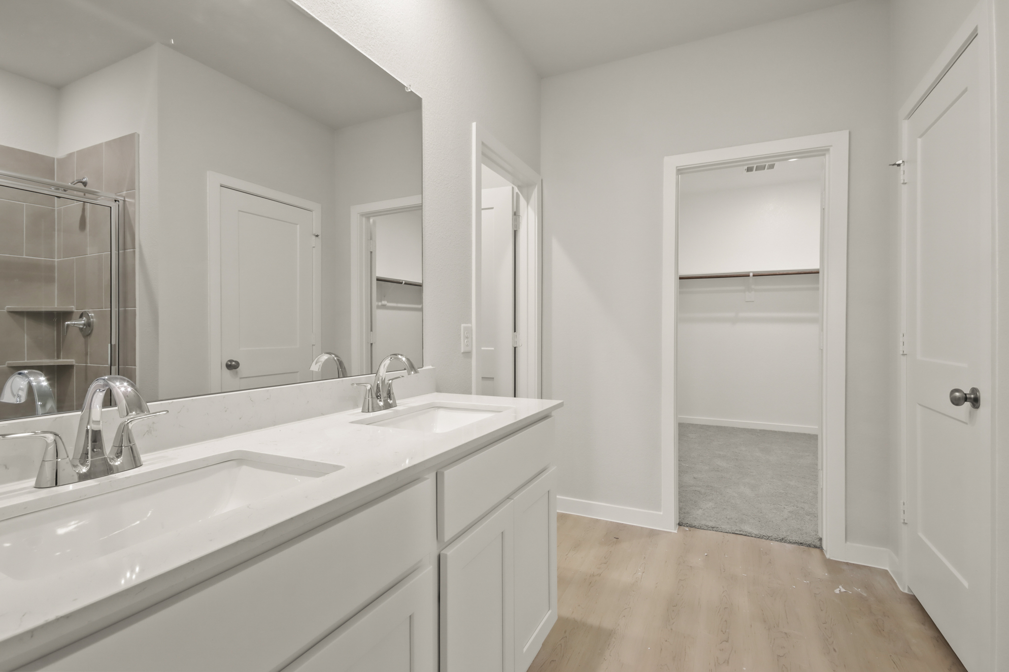 A bathroom with white cabinets.