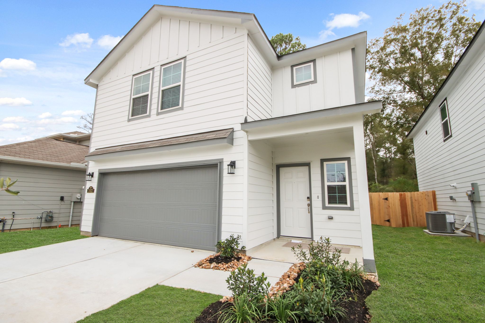 A white house with a garage.