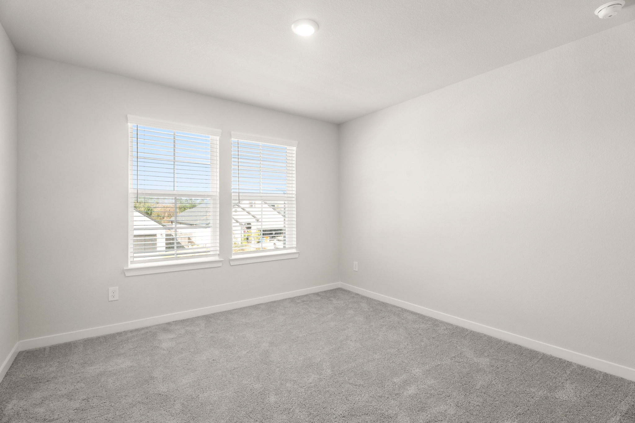 A room with a window and a carpet.