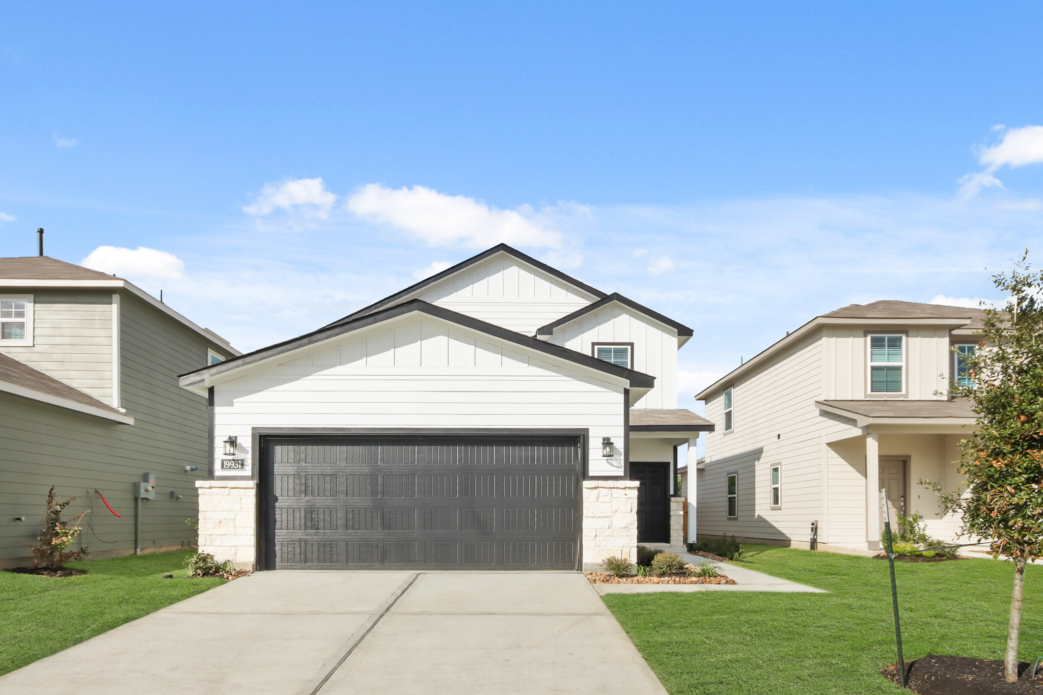 A white house with a garage.
