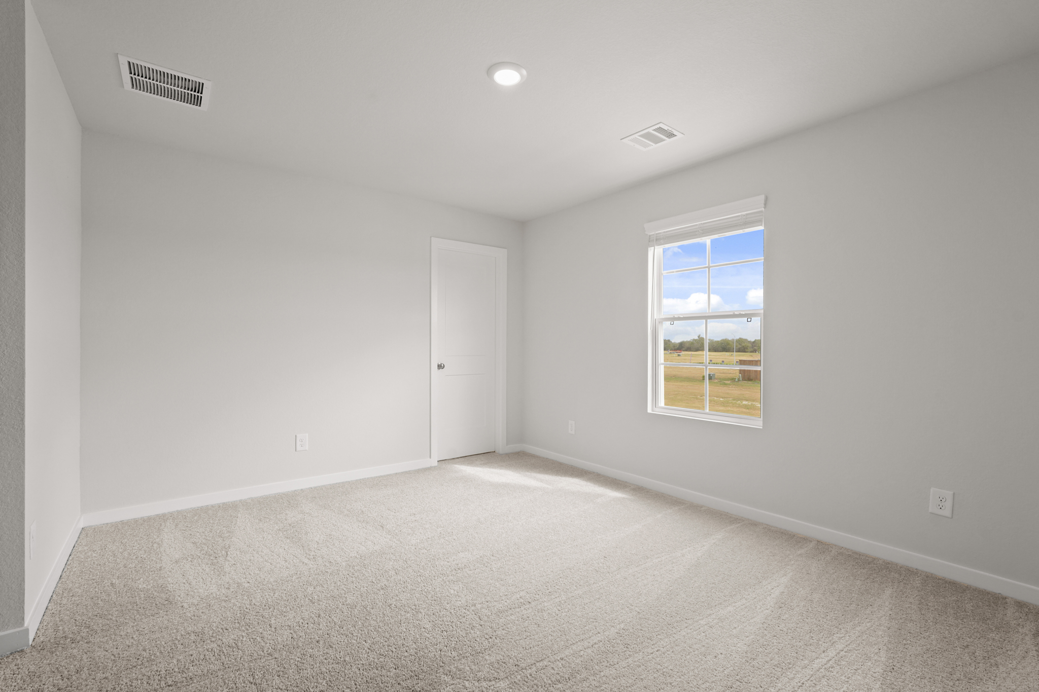 A room with a window and a door.