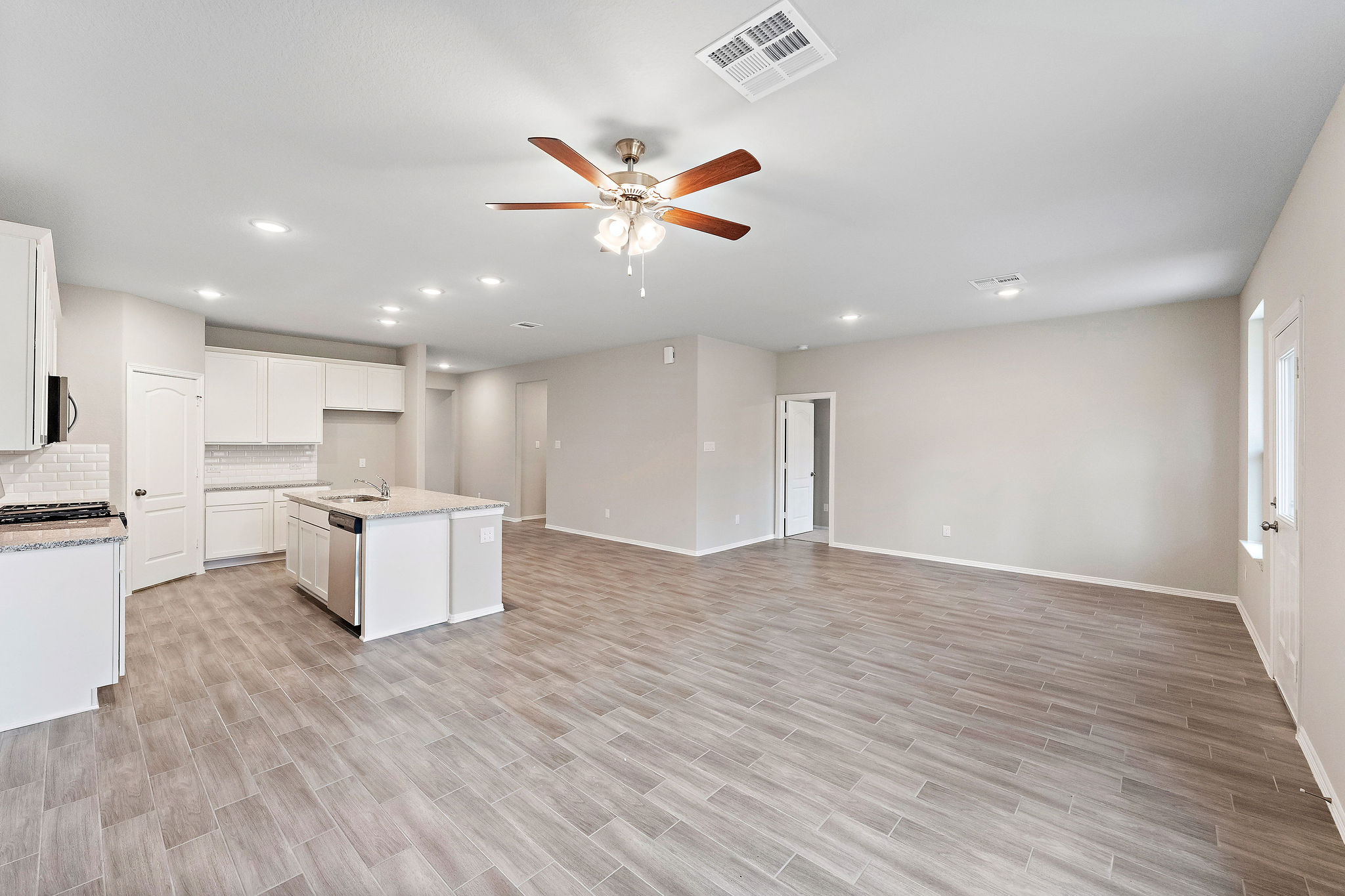A large kitchen with white cabinets.