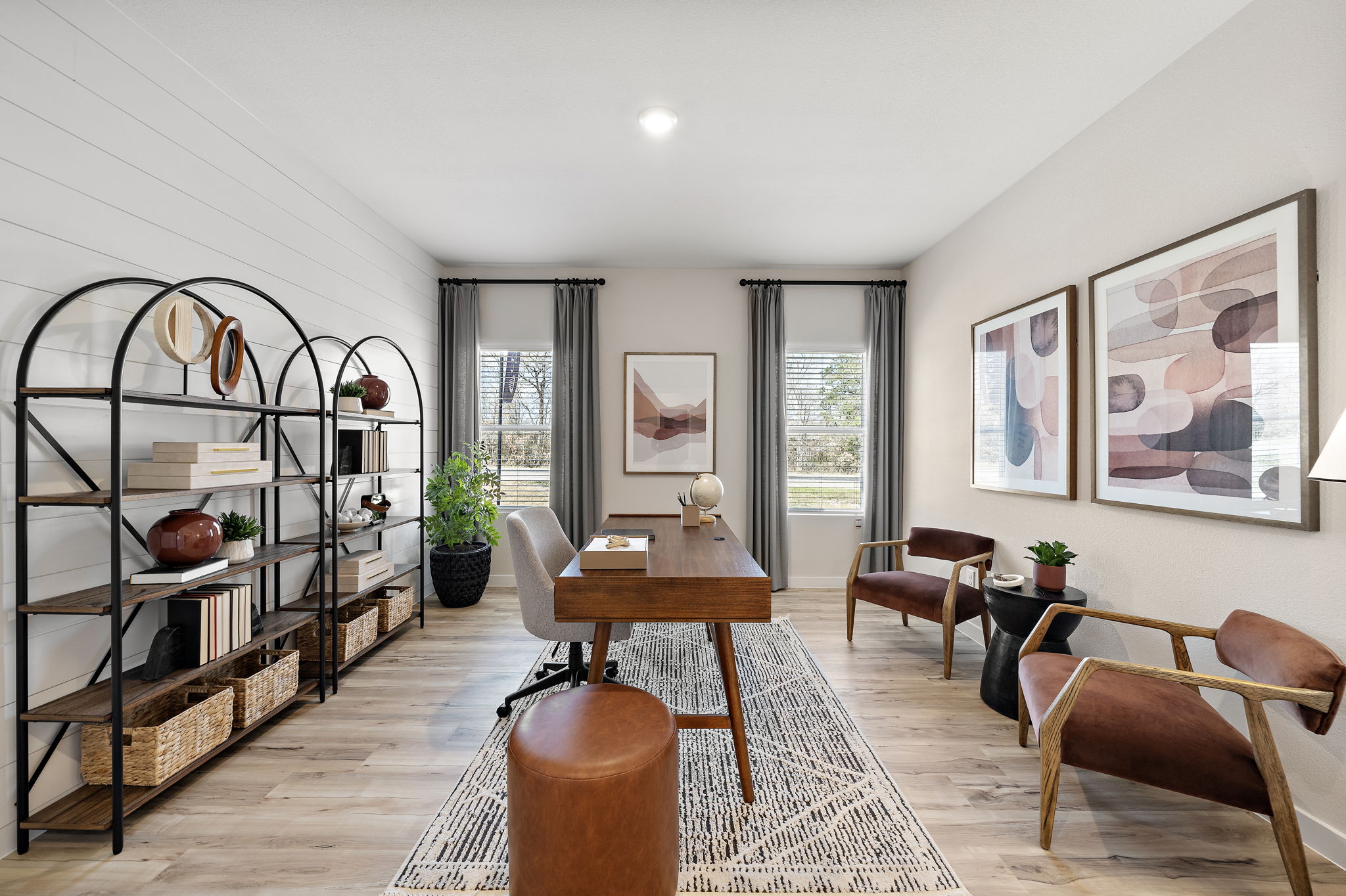 A living room with a table and chairs.