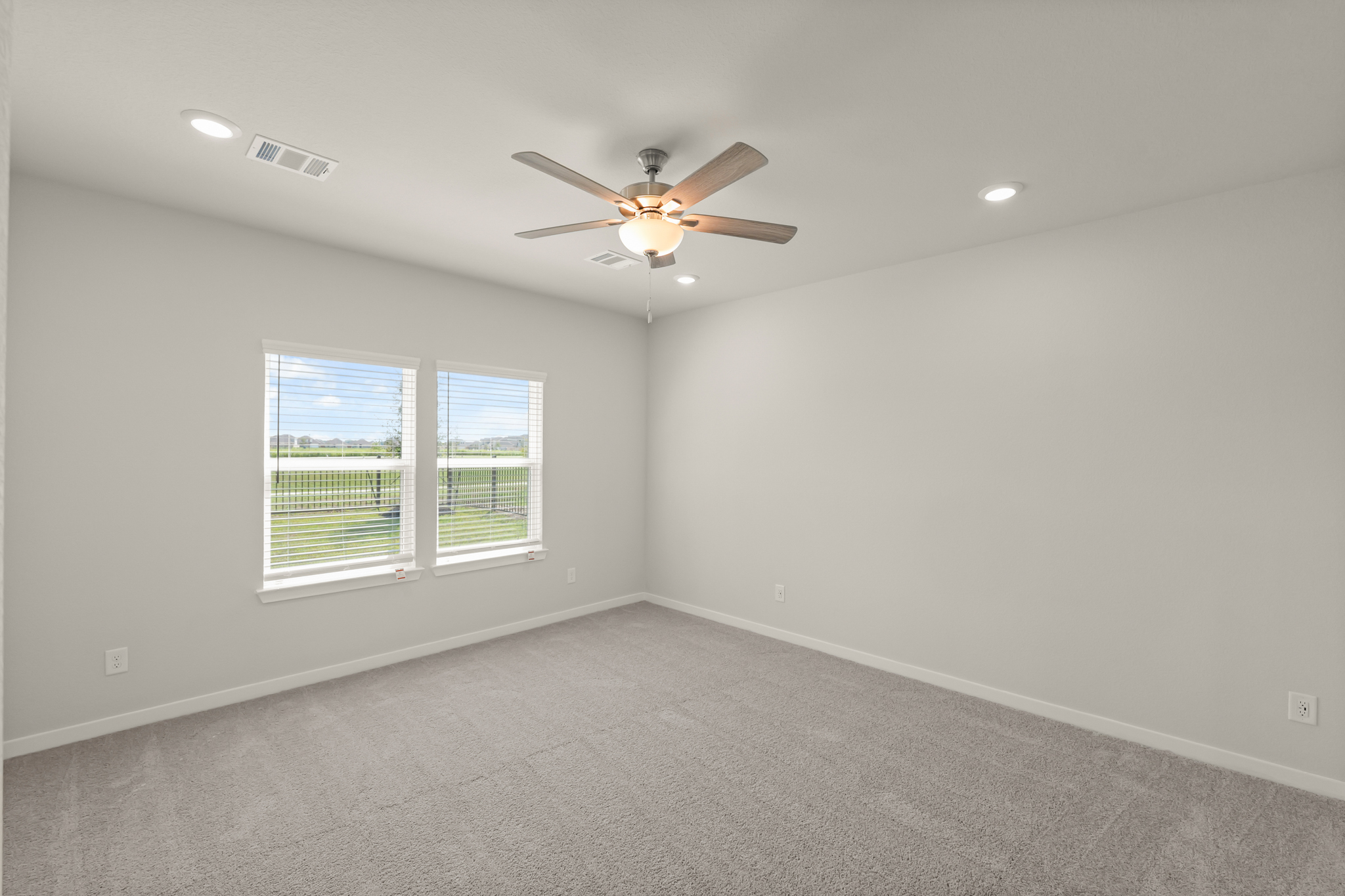A room with a ceiling fan and a window.