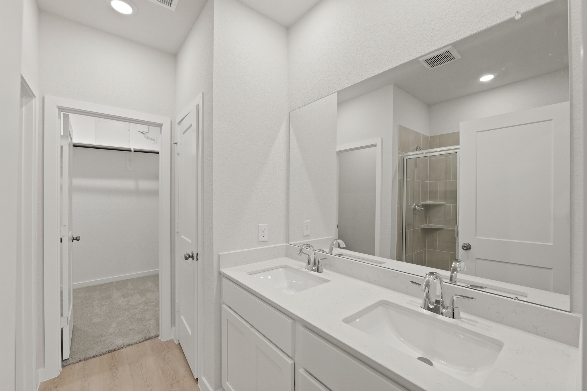 A bathroom with a large mirror.