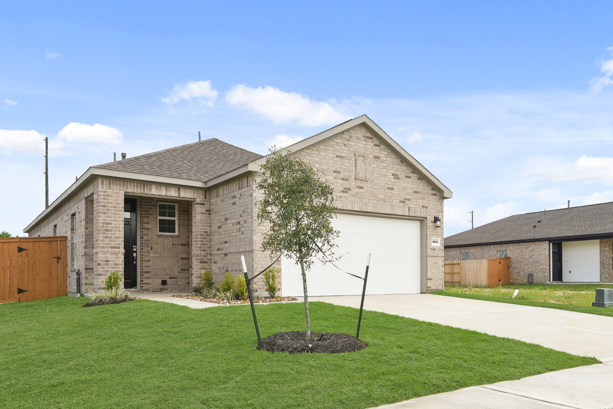 A house with a tree in the front yard.