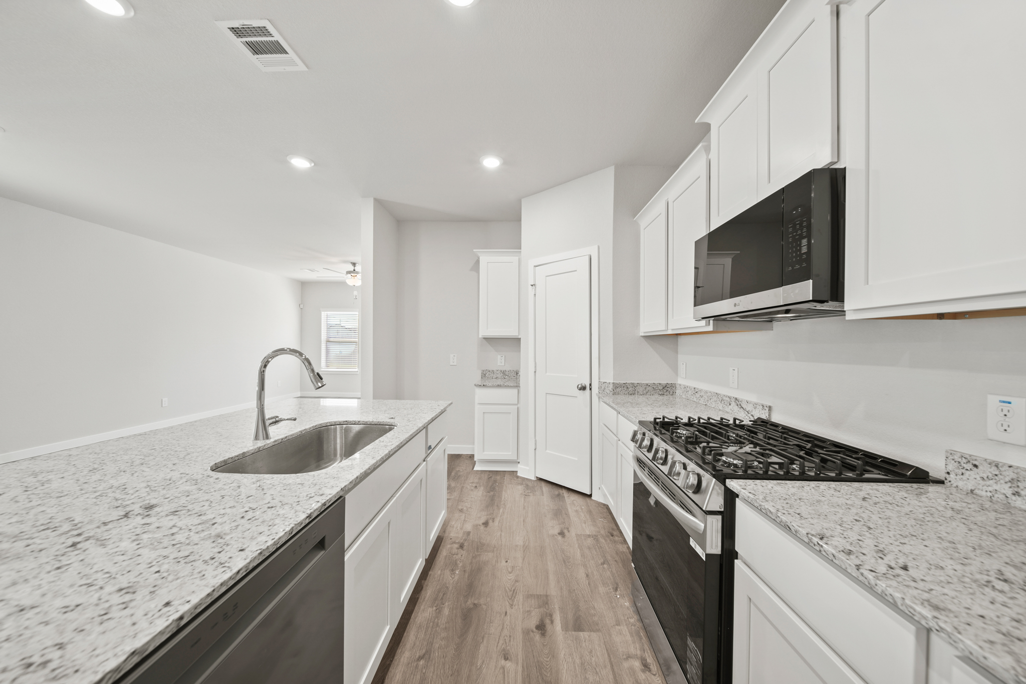 A kitchen with white cabinets.