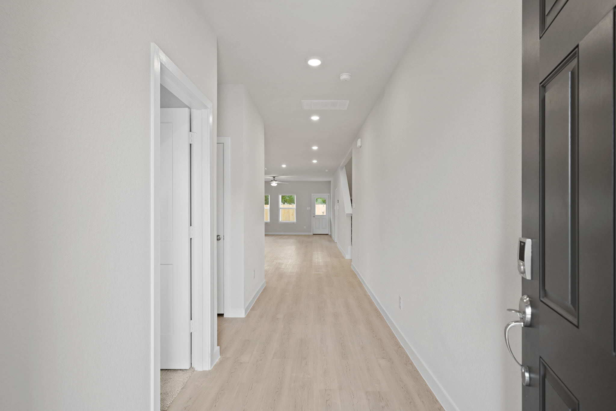 A hallway with white doors.