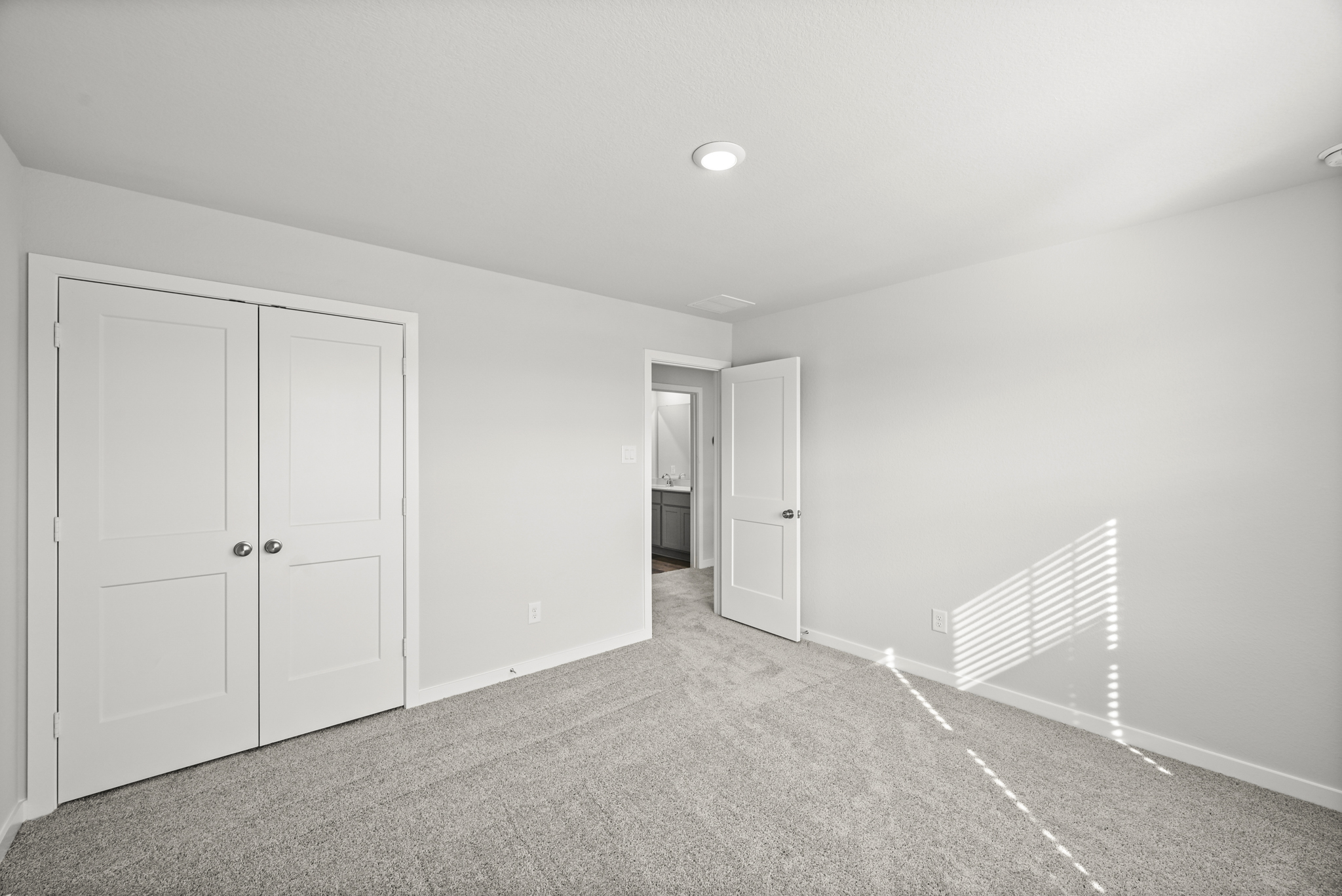 A hallway with white doors.