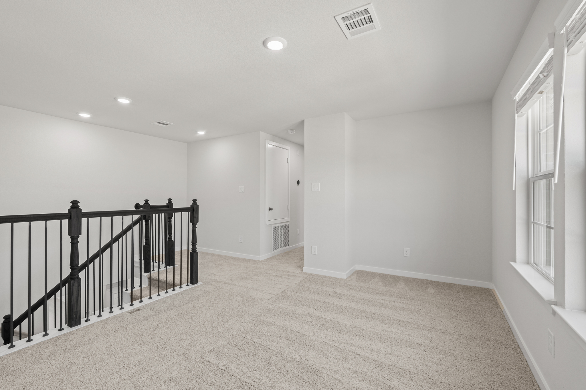 A hallway with a railing.