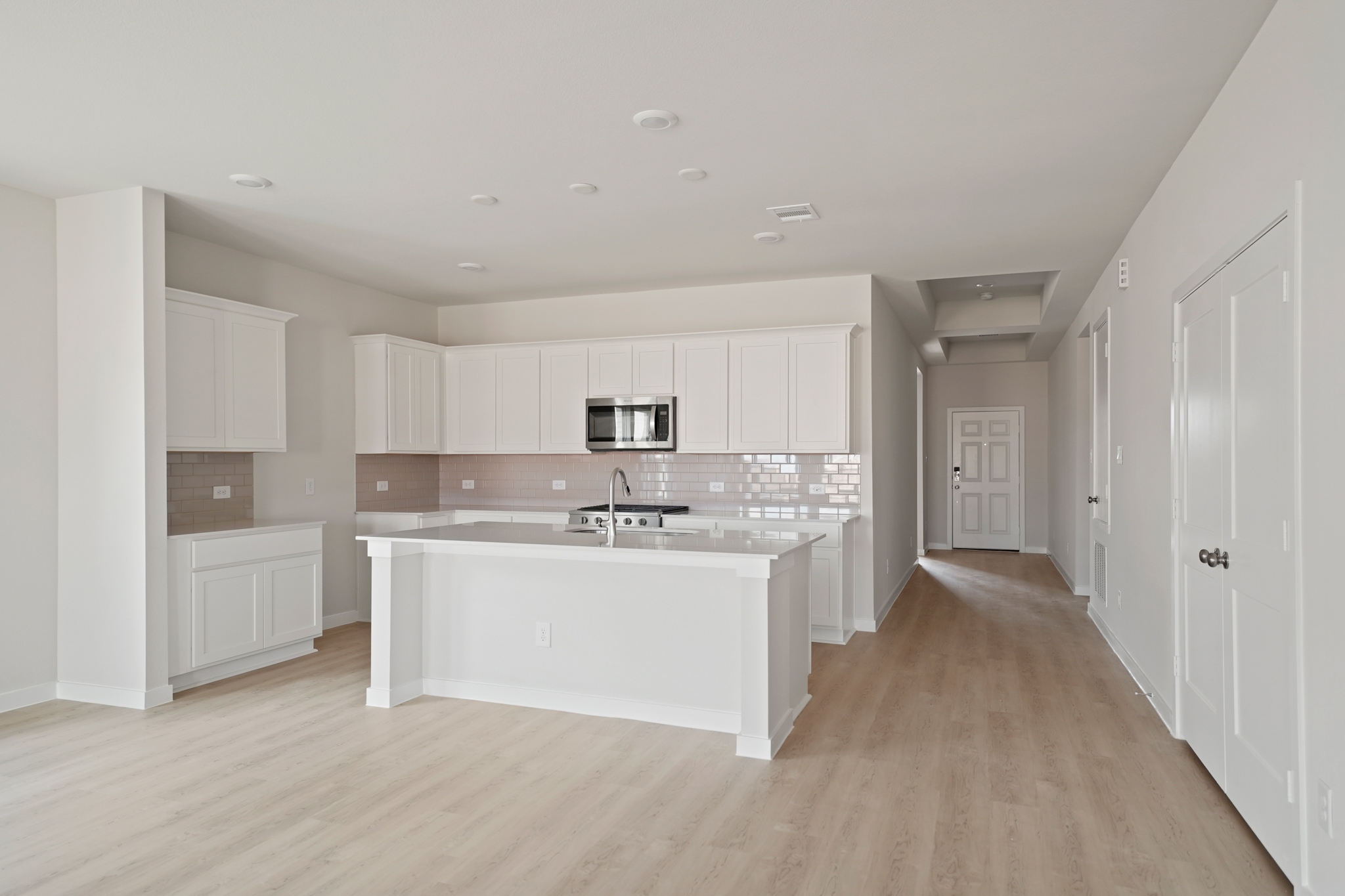 A large kitchen with white cabinets.