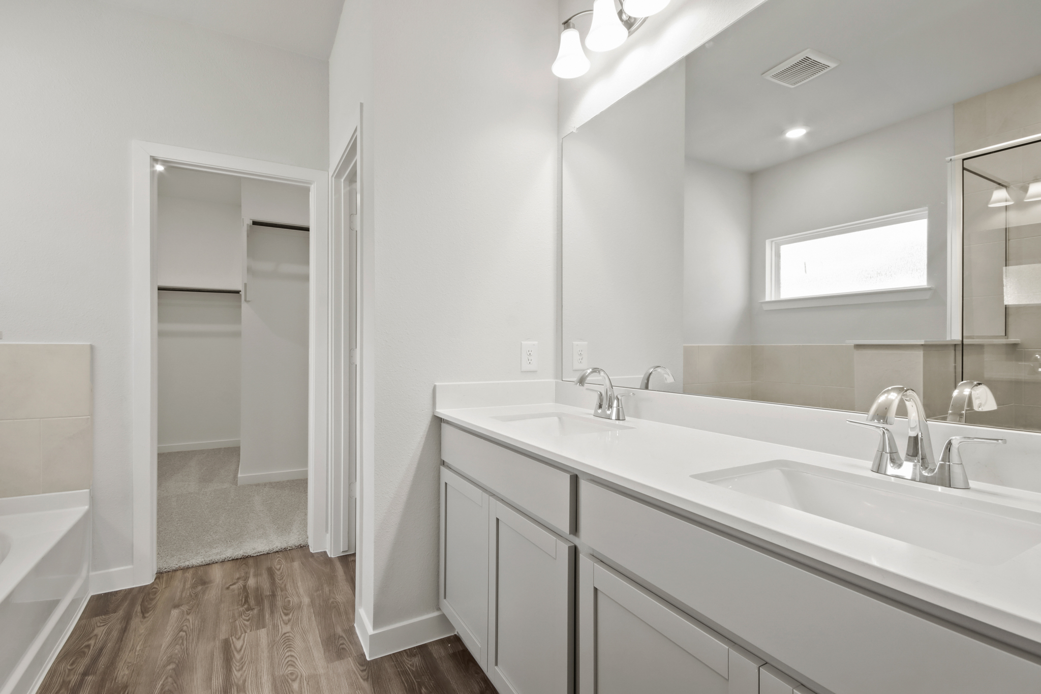 A bathroom with a large mirror.