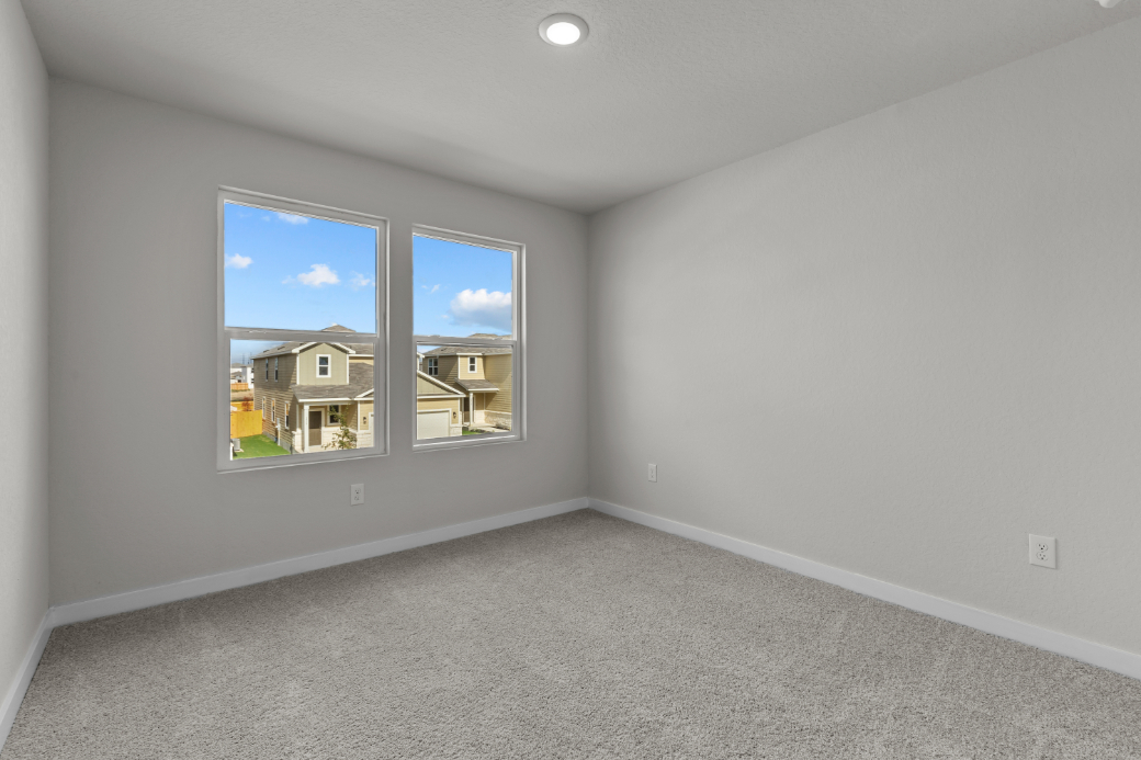 A room with a window and a carpet.