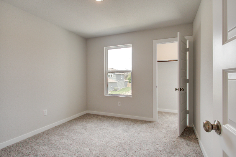 A room with a window and a door.