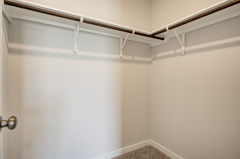 A white wall with a metal railing.
