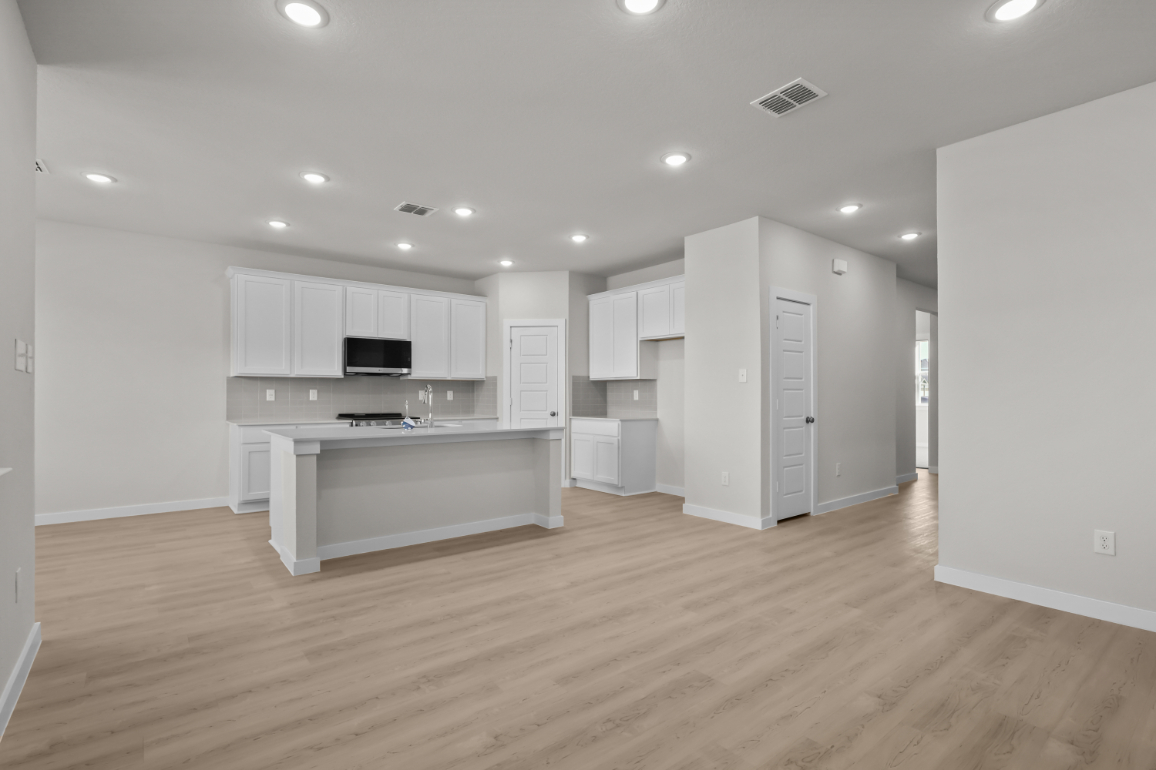 A large kitchen with white cabinets.